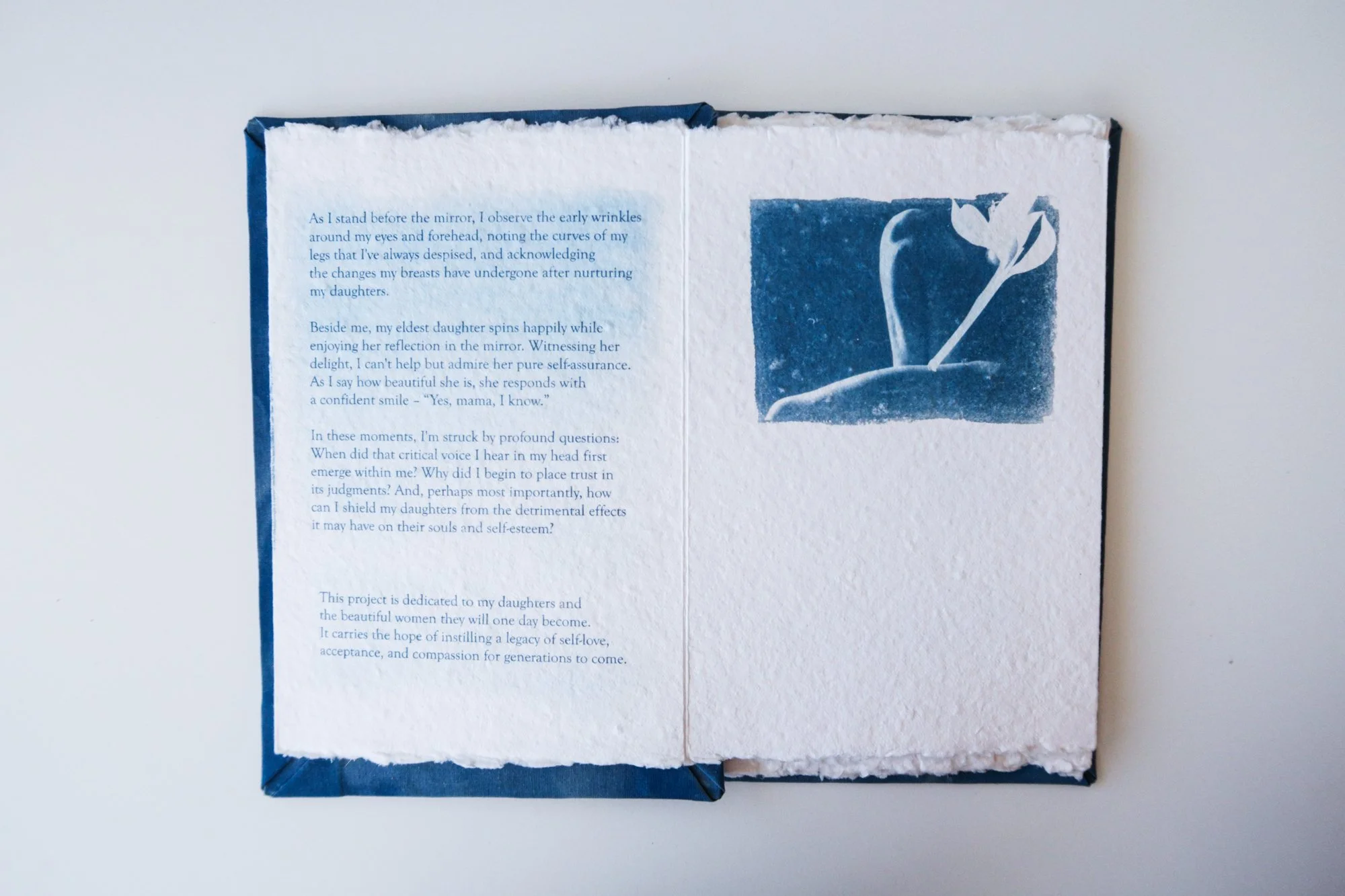 Page from a handmade artist book by Yanina Shevchenko, part of her project If I Loved You As I Should — a body-focused exploration of self-acceptance. Printed on handmade paper using cyanotype, the image combines body forms and natural elements