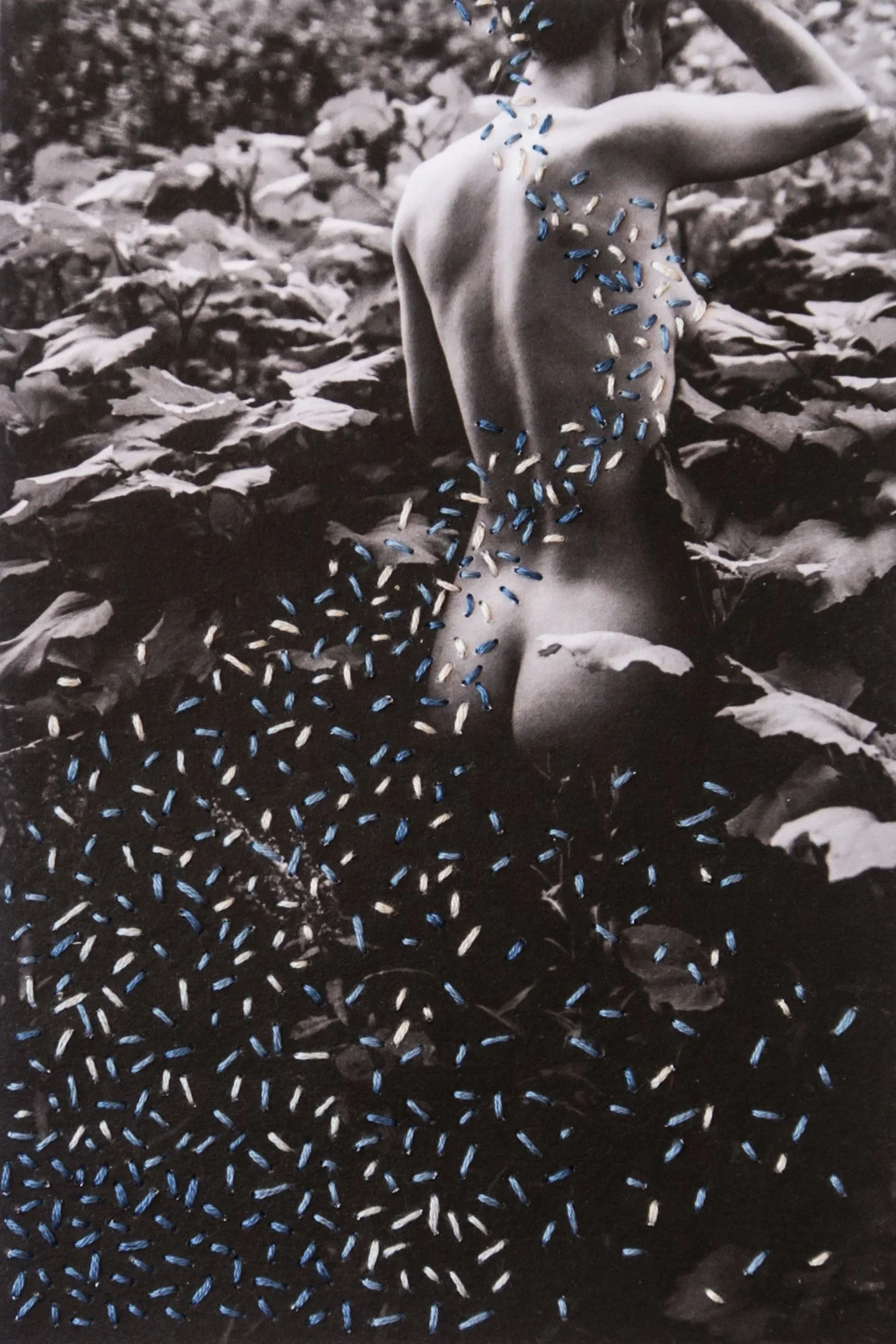 A photograph combining nude body, thread, and nature, photo embroidery on paper by Yanina Shevchenko, an artwork from her project We Are One