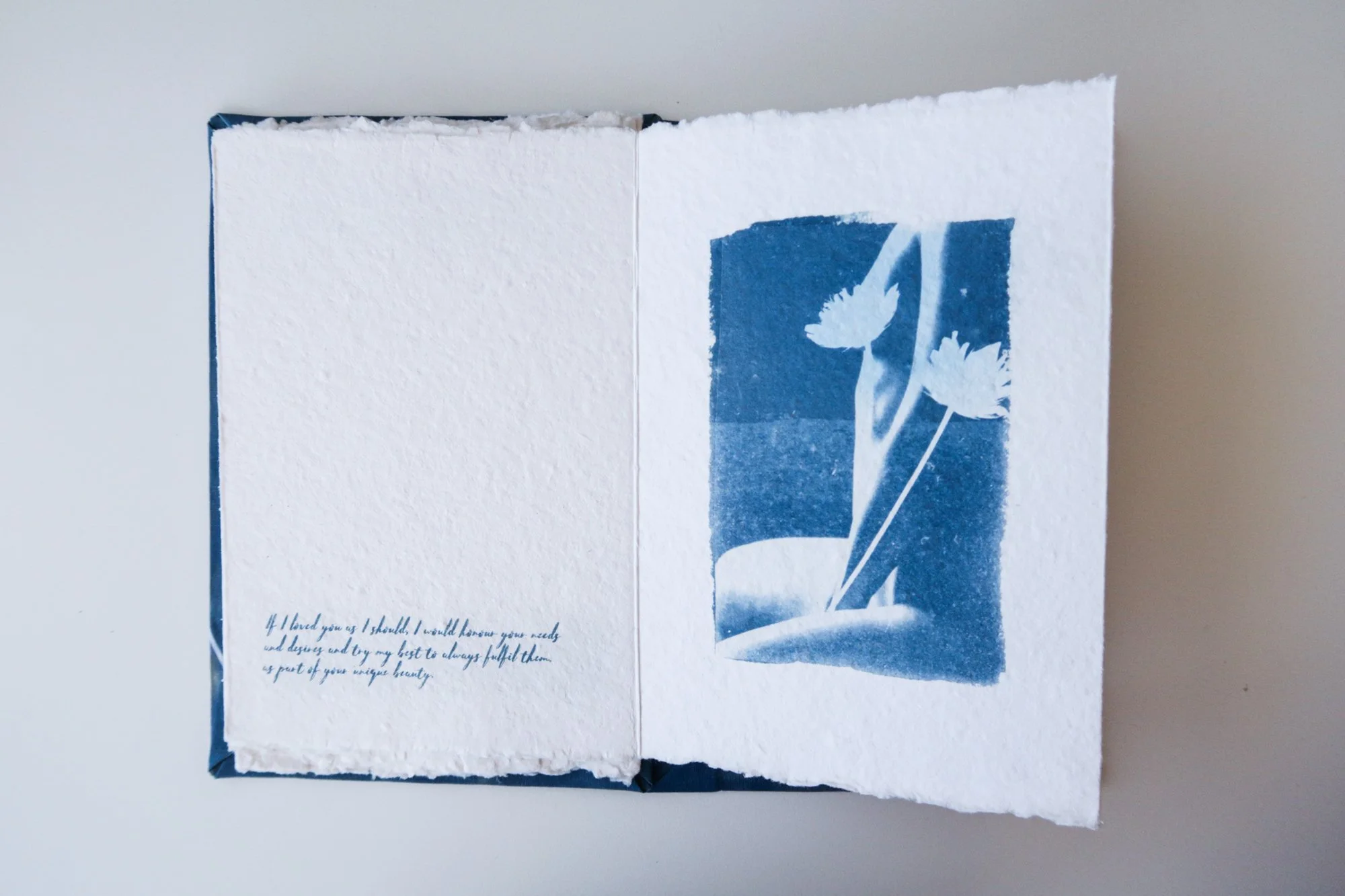 Page from a handmade artist book by Yanina Shevchenko, part of her project If I Loved You As I Should — a body-focused exploration of self-acceptance. Printed on handmade paper using cyanotype, the image combines body forms and natural elements