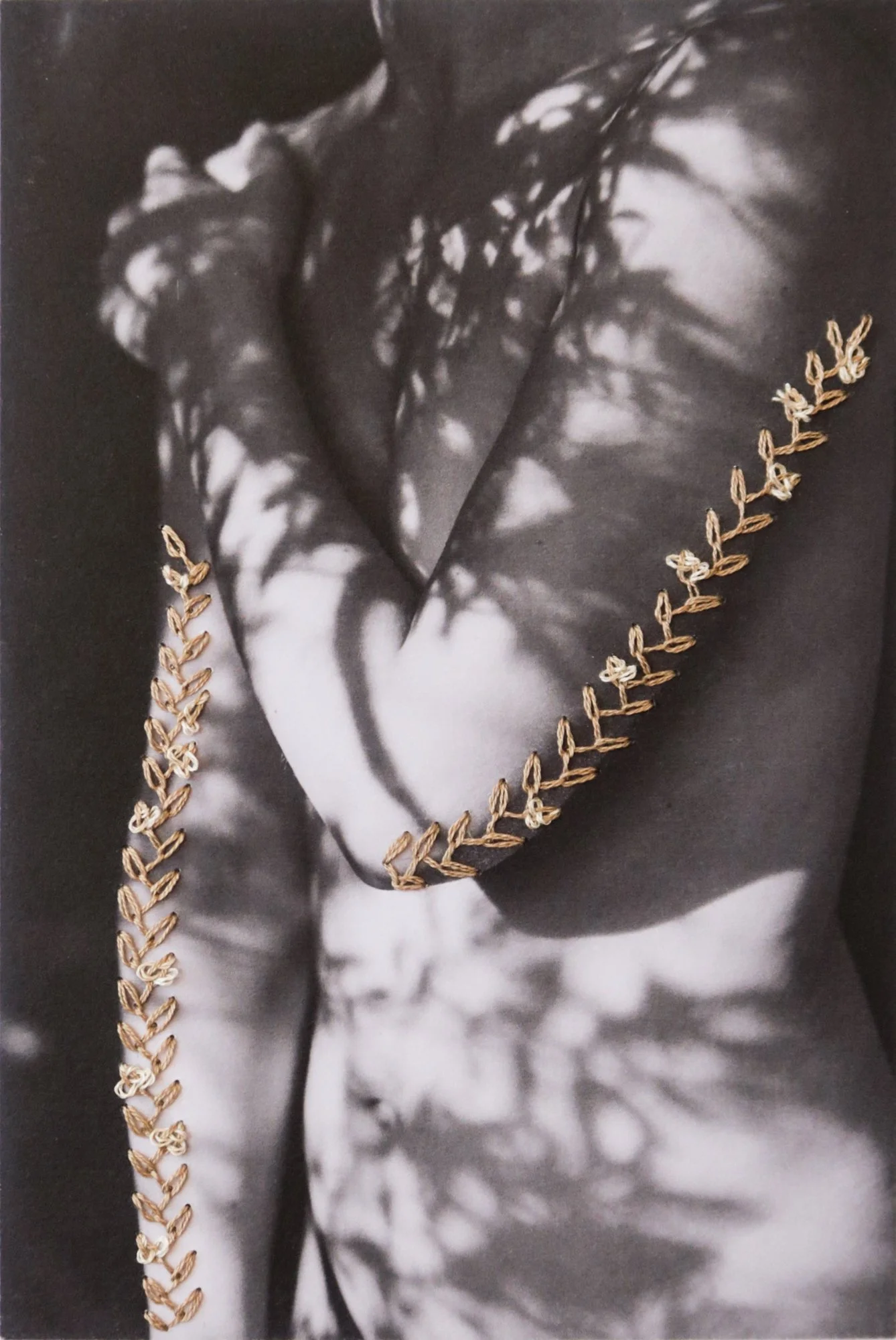 A photograph combining nude body, thread, and nature, photo embroidery on paper by Yanina Shevchenko, an artwork from her project We Are One
