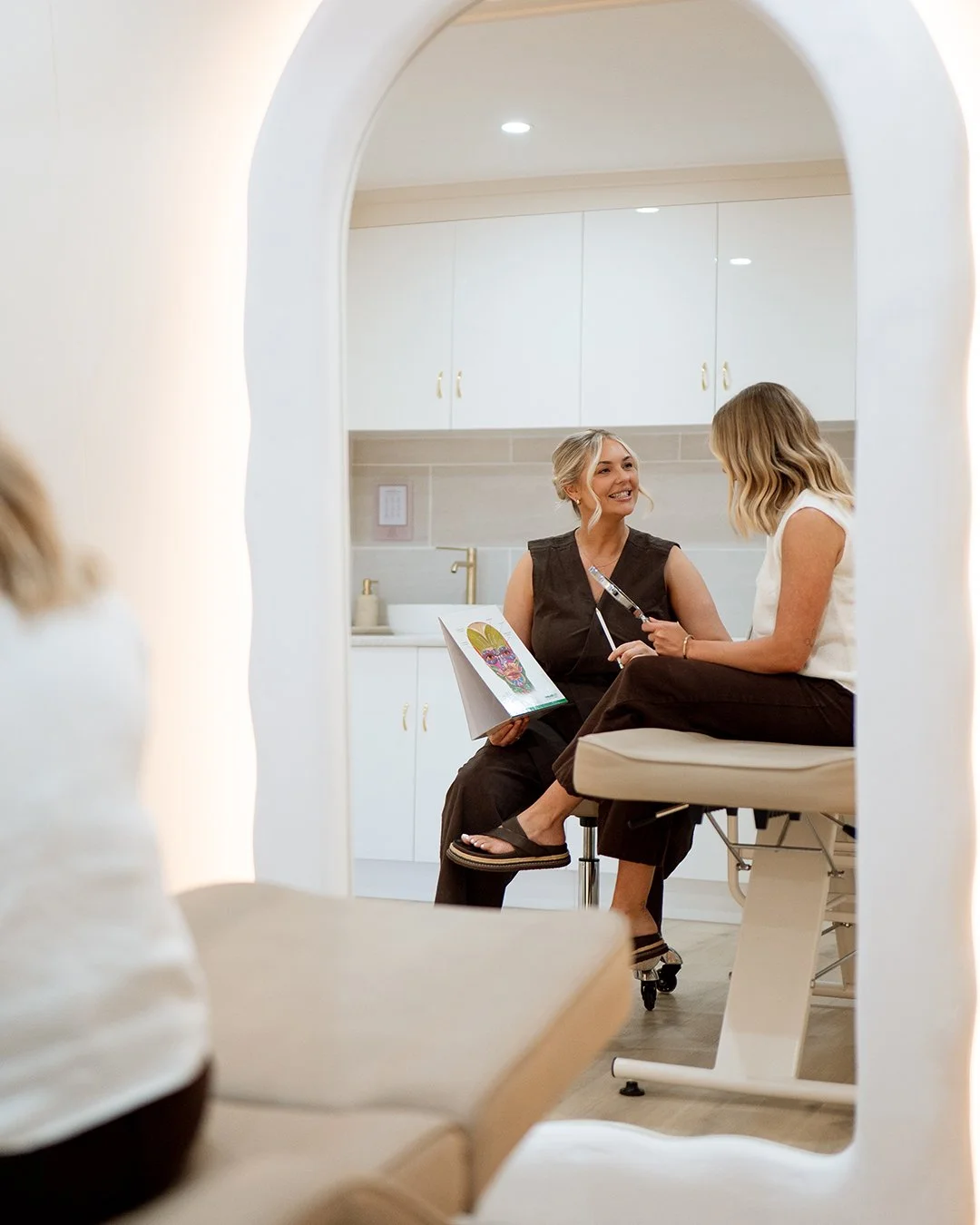Cosmetic nurse in a consultation with her patient
