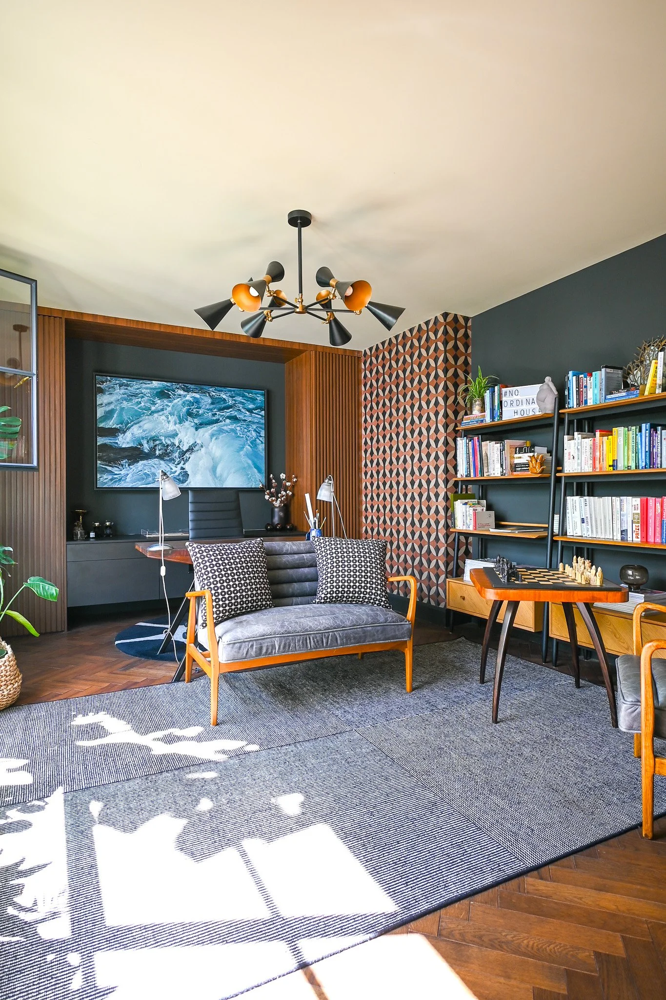 study with sofa and wooden desk, panelling and a rug