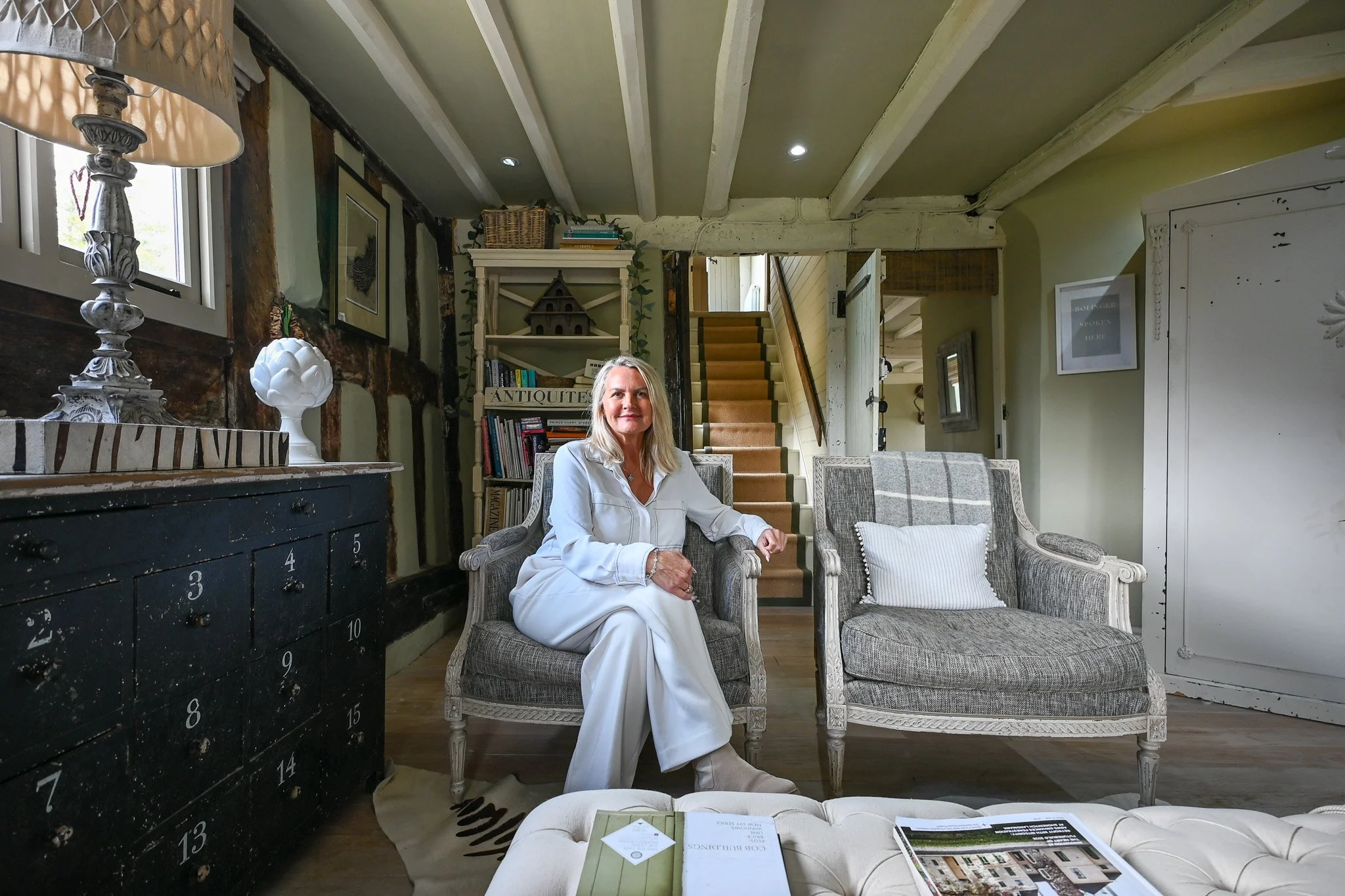 women sitting in living room armchair looking at the camera of a grade 2 listed cottage