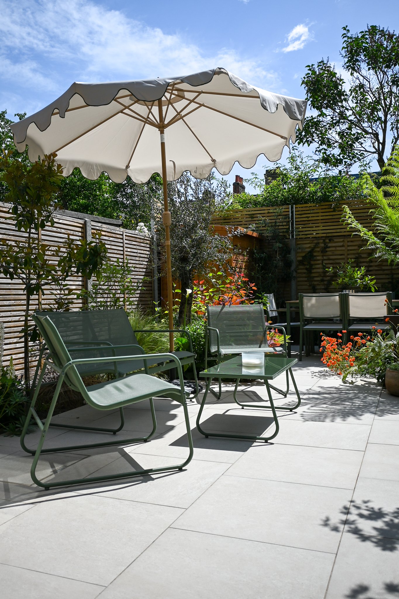view of the garden area with seating and marble outdoor tiles