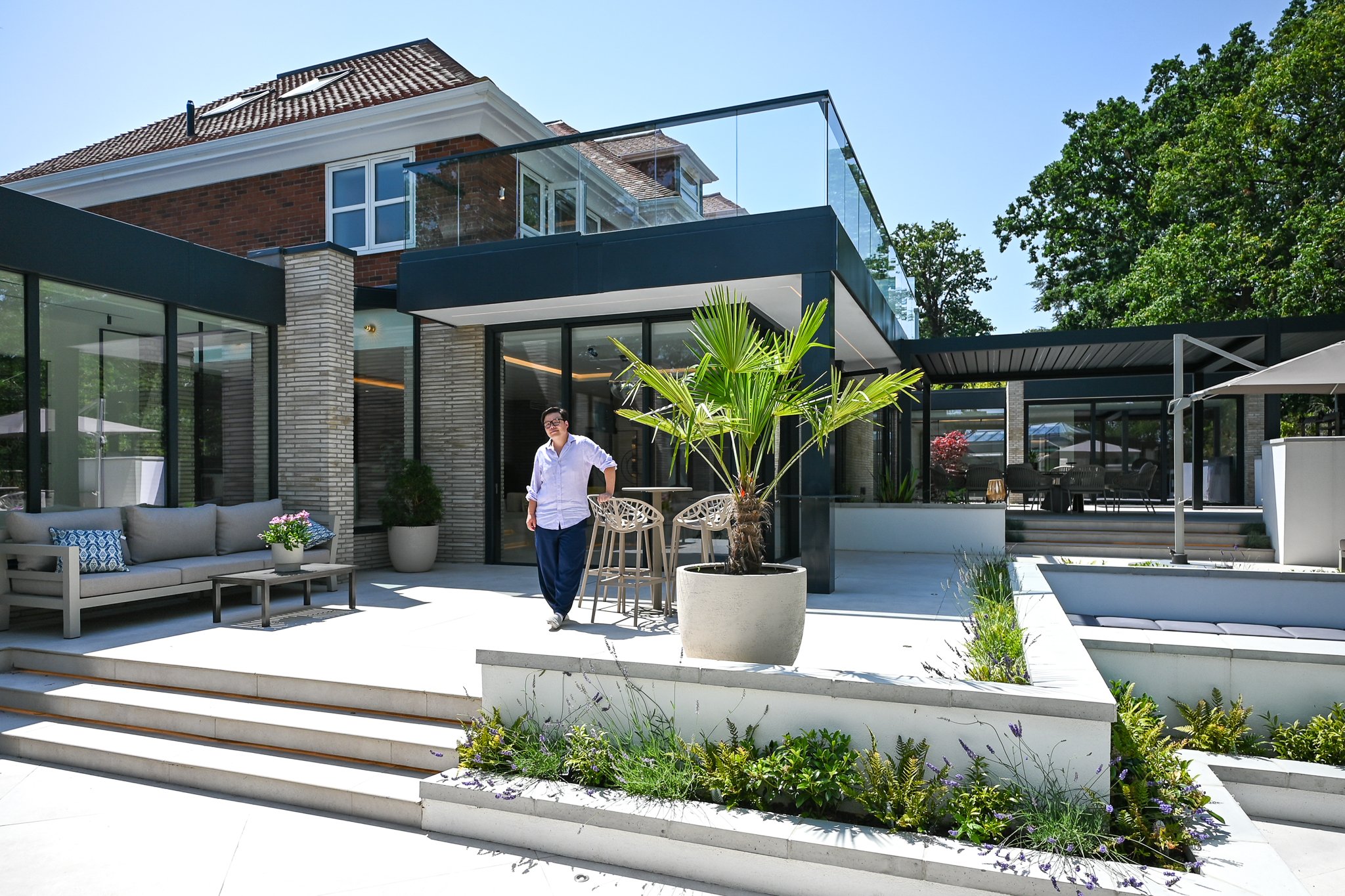 Architect Youno standing in front of extension architecture and their latest project in kingston