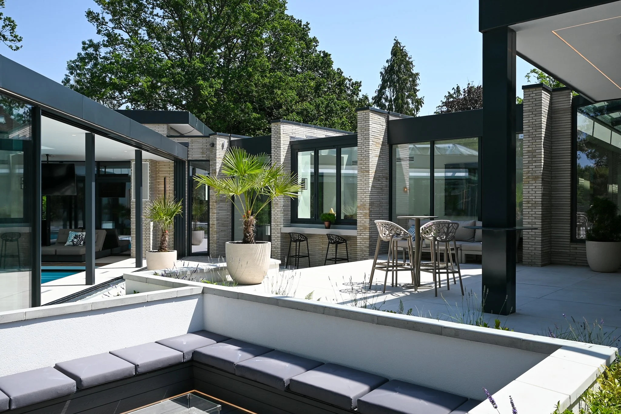outside seating area with sunken seating and pool house view