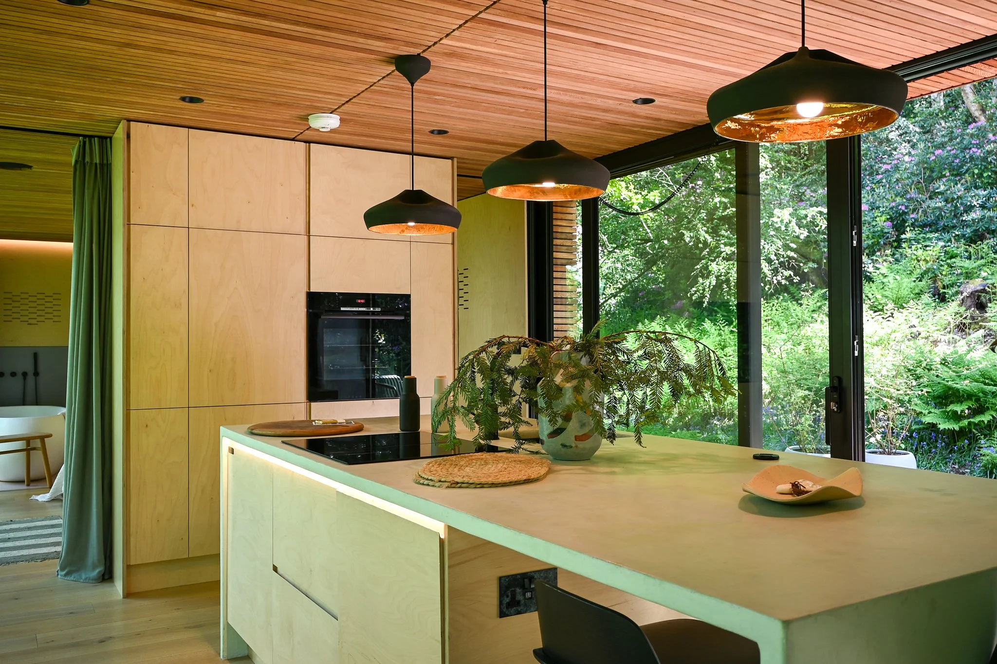 Looking Glass Lodge Kitchen View With Hanging Lights and Island