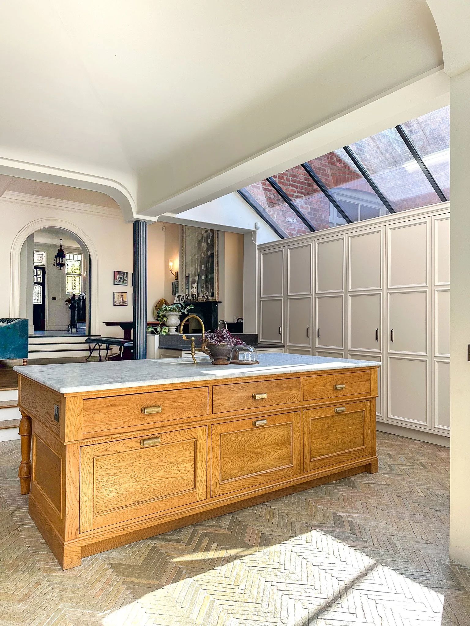 kitchen island with marble worktop in open plan kitchen and roof lights