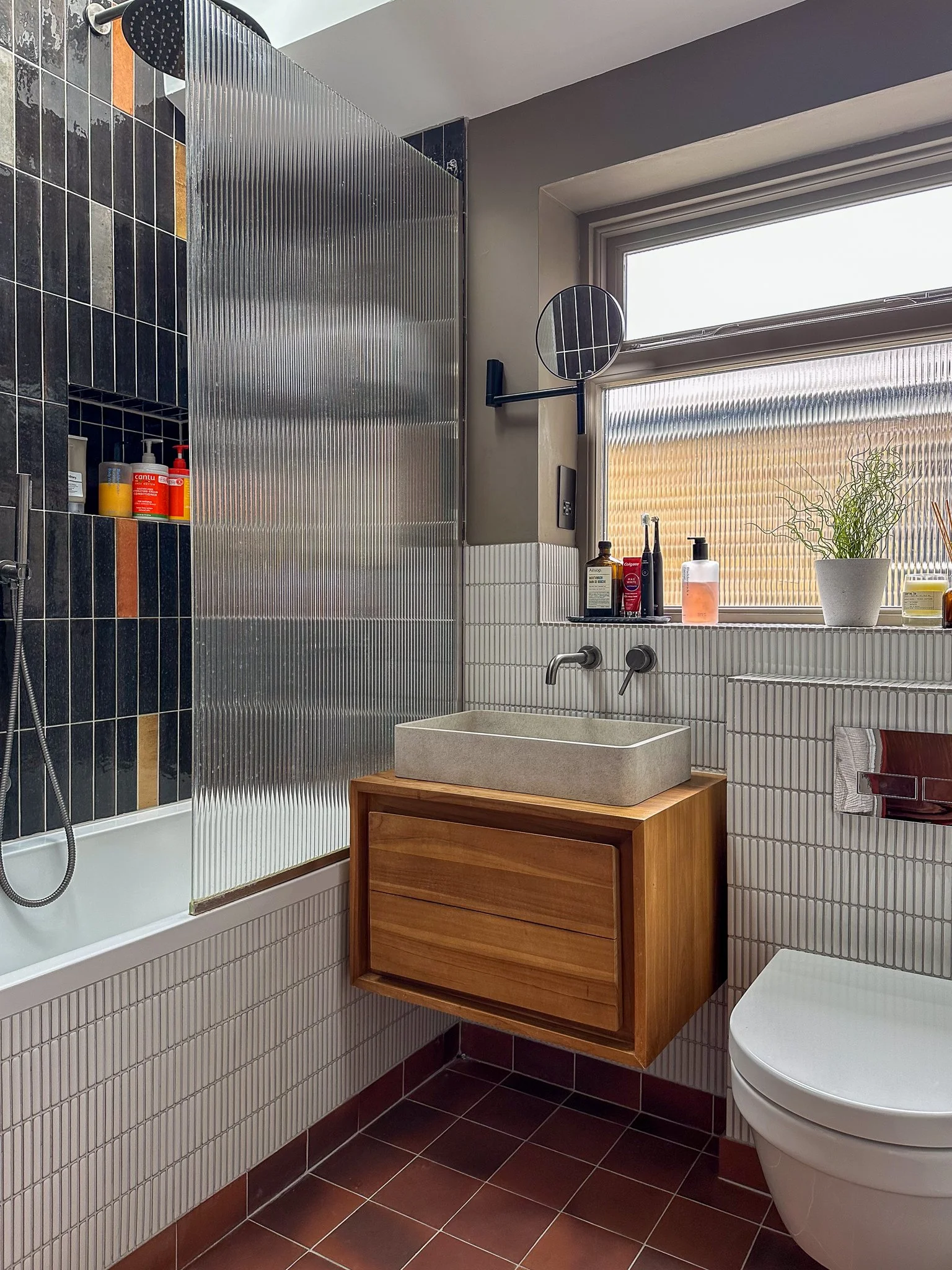 Hackney Home Upstairs Bathroom with Mismatch Tiling and Fluted Glass
