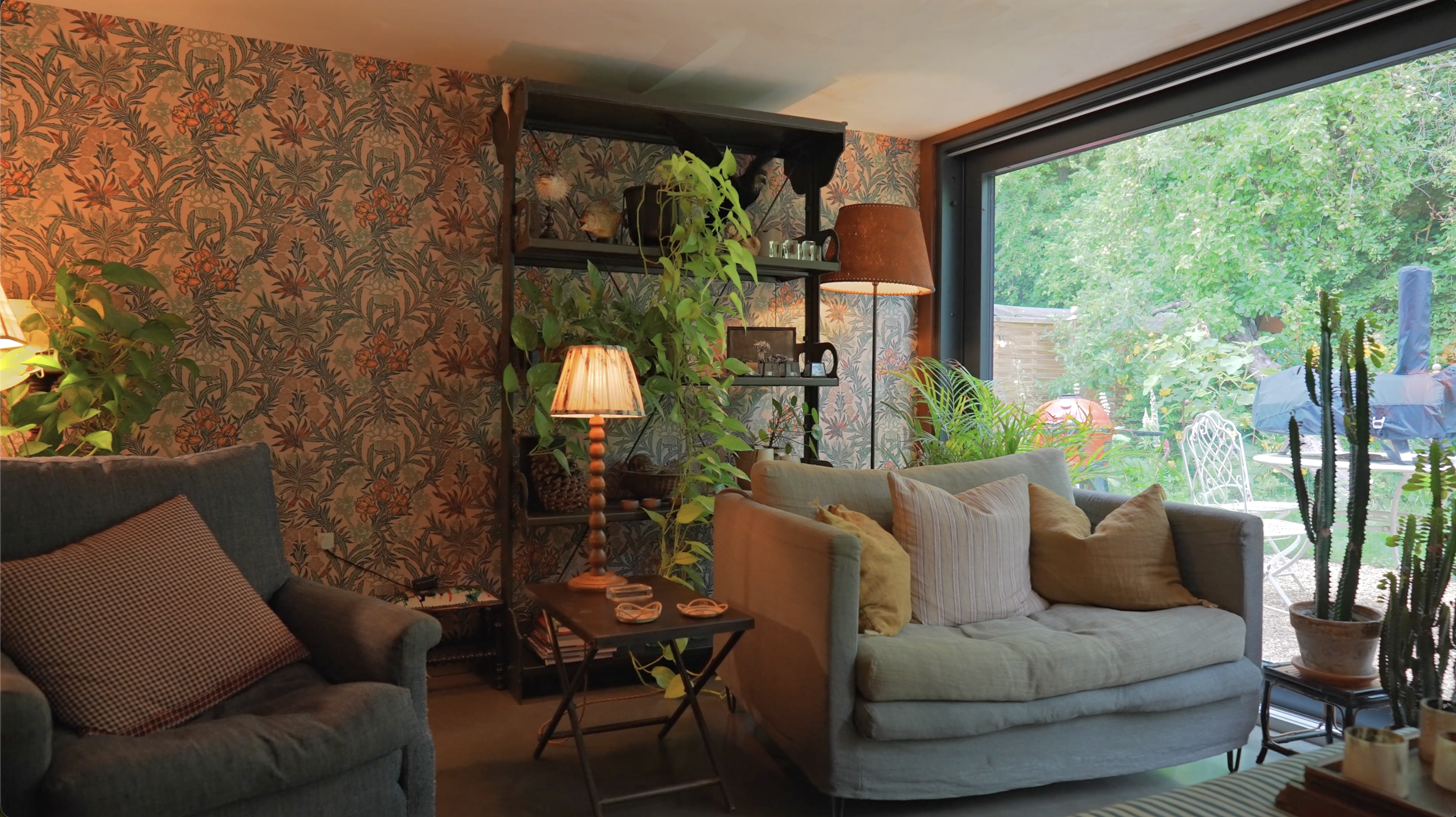 living room area with patterned wallpaper and traditional interiors