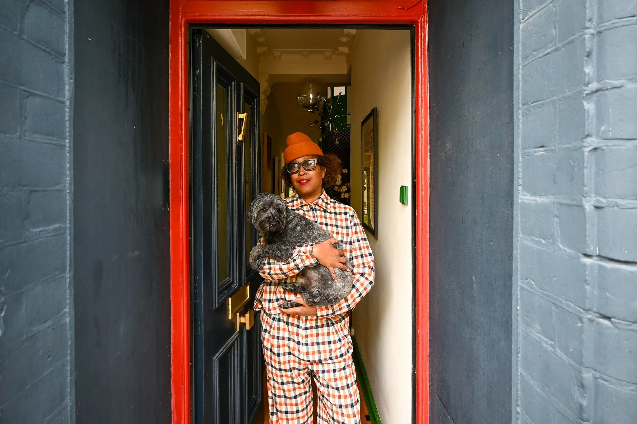 women standing in doorway with her dog in her hands