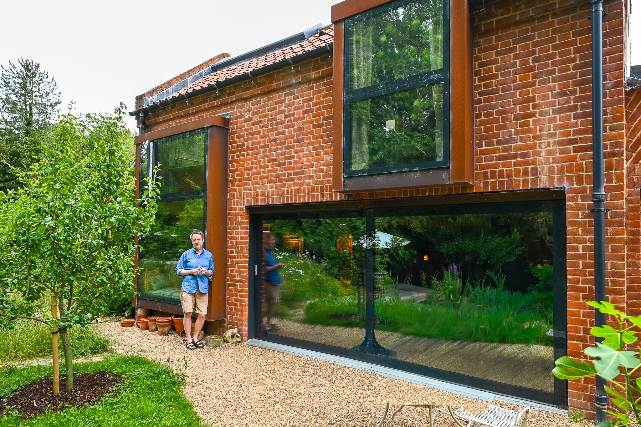 owner and renovator alan outside the rear of his cottage in norfolk