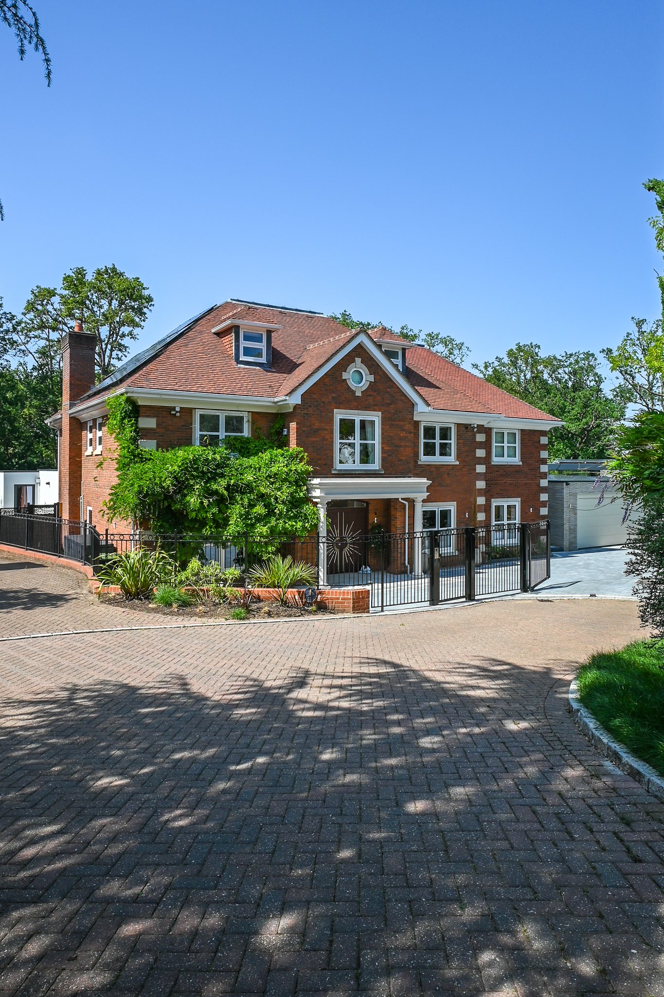 Front Elevation Red Bricked Home with Private Drive