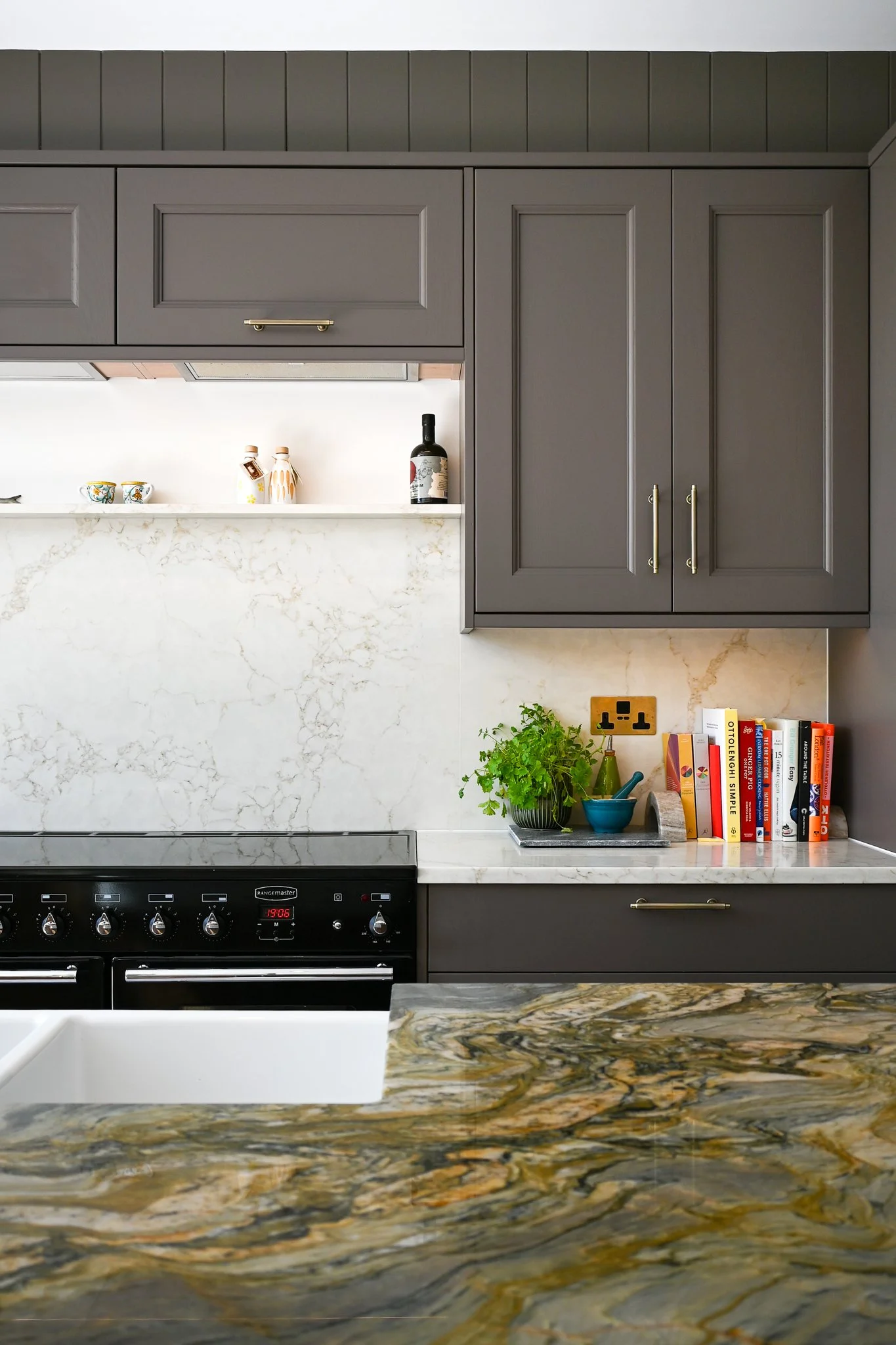 kitchen cupboards with a marble splashback and a marble island