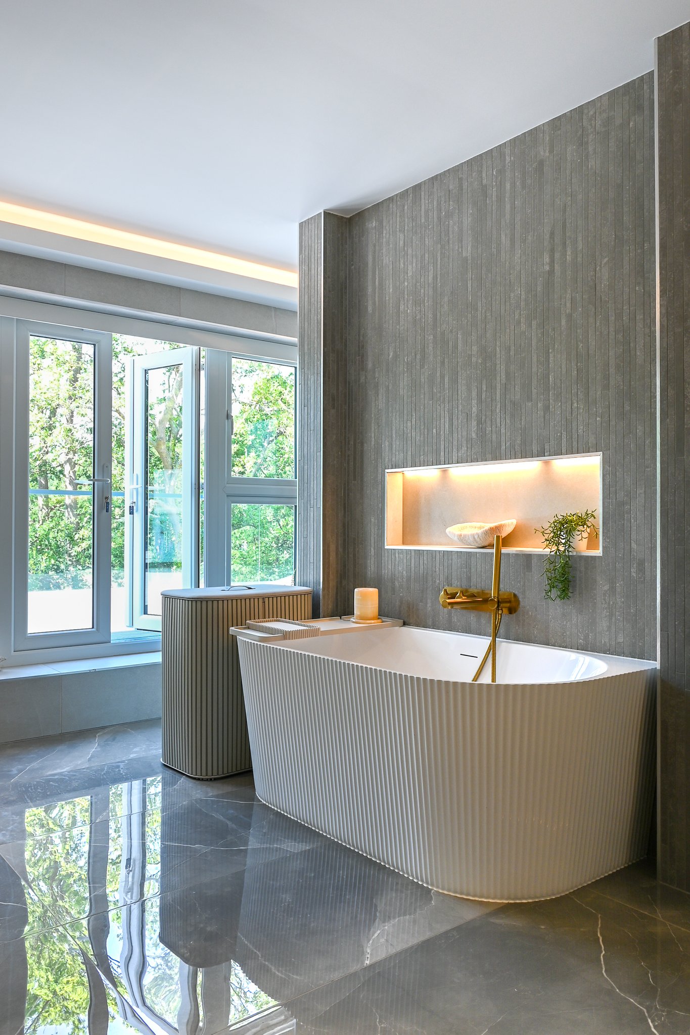 large principal en-suite with freestanding bath and double doors out to the balcony