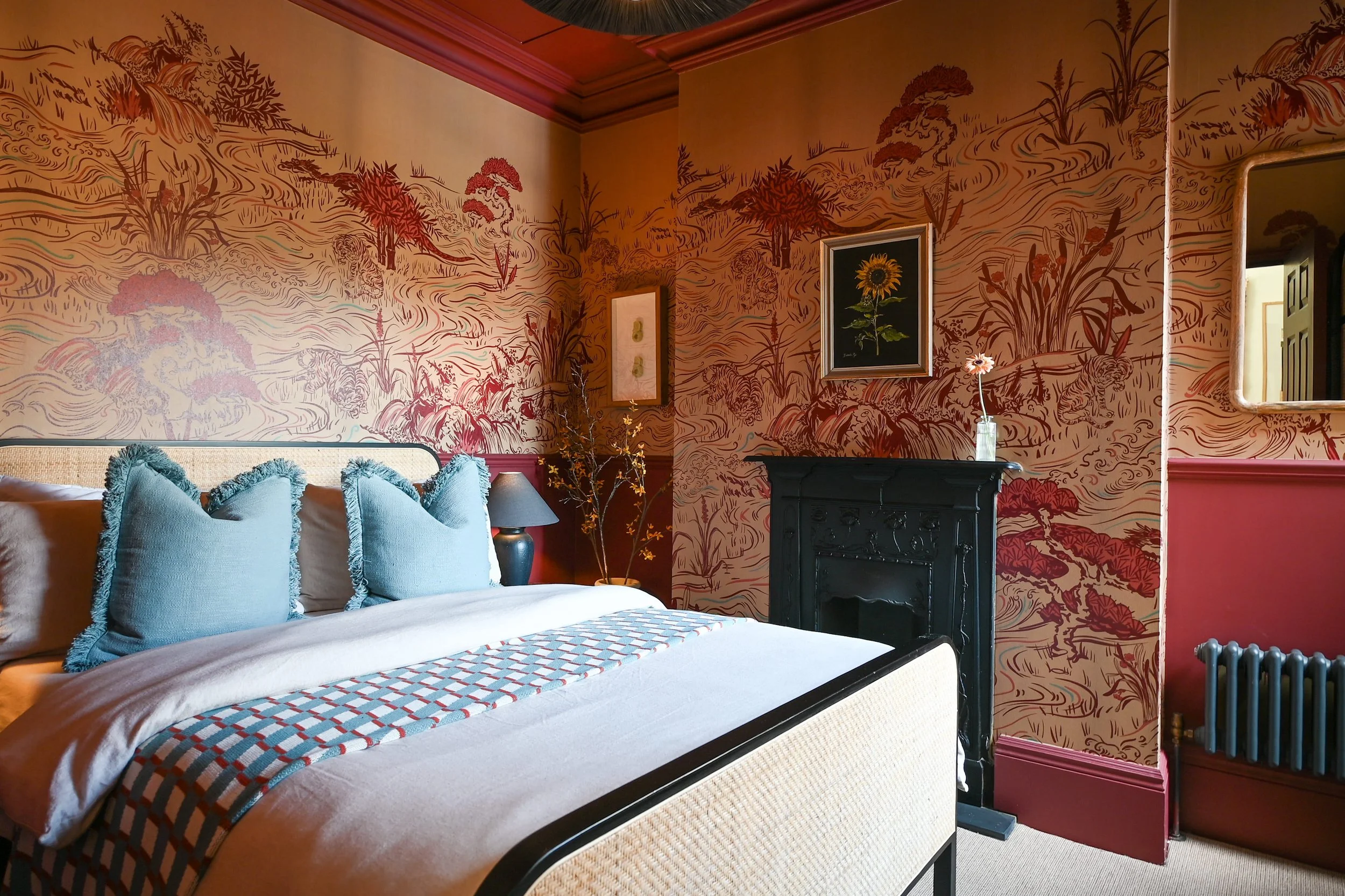 wallpapered bedroom with period fireplace