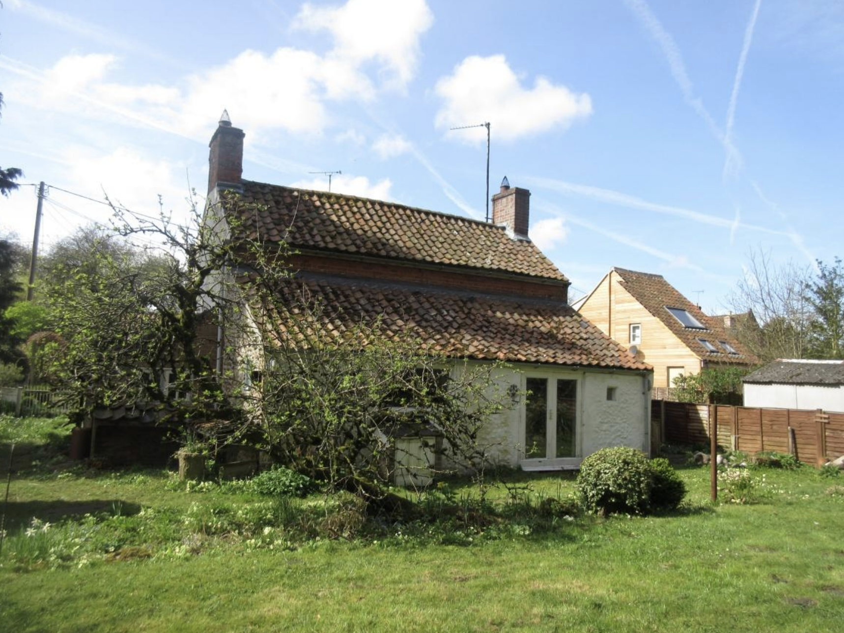 rear elevation of an old cottage in norfolk with lean to extension
