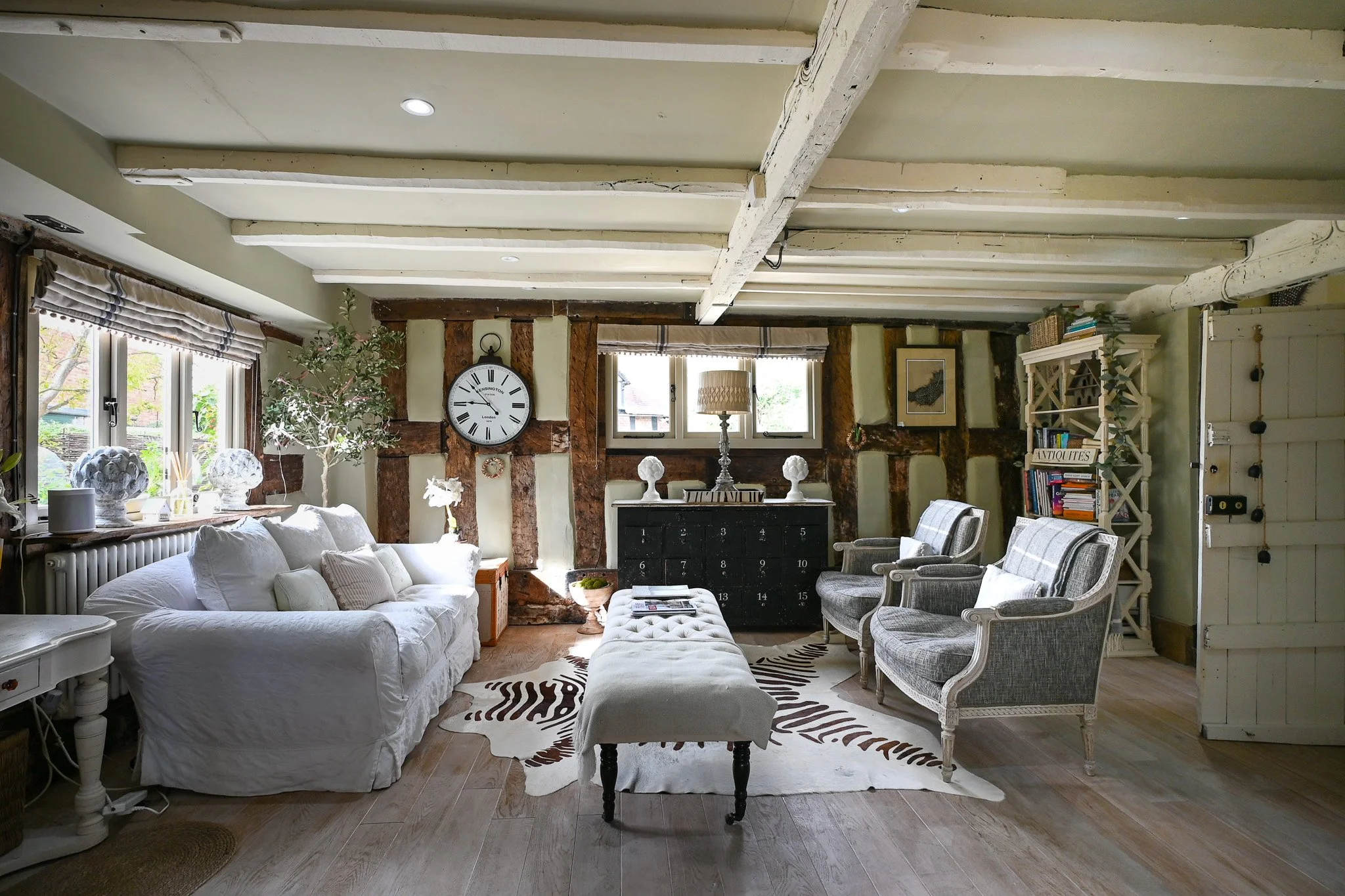 living room with wooden flooring, timber beams and wooden doors
