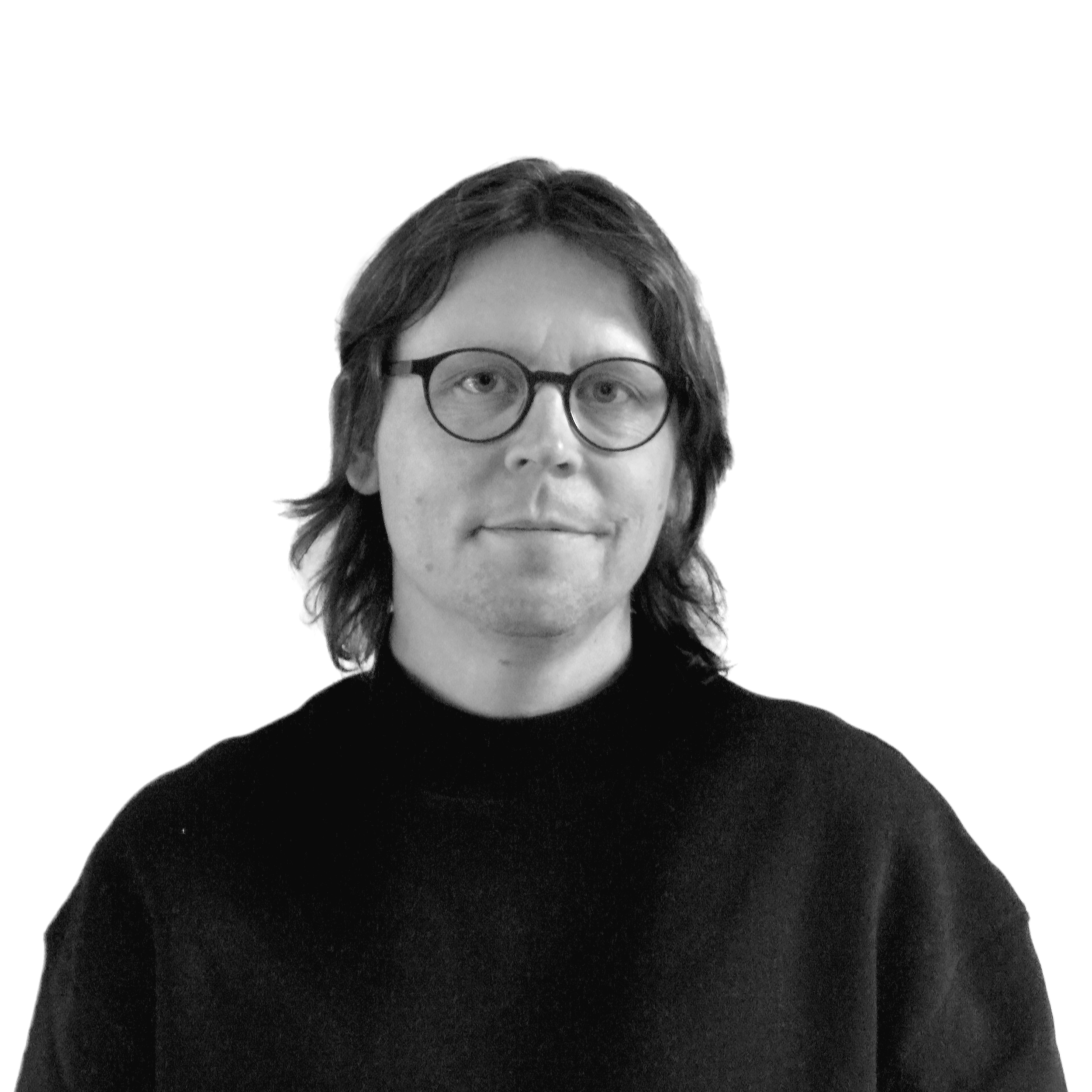 Person with glasses and long hair wearing a dark sweater against a white background.