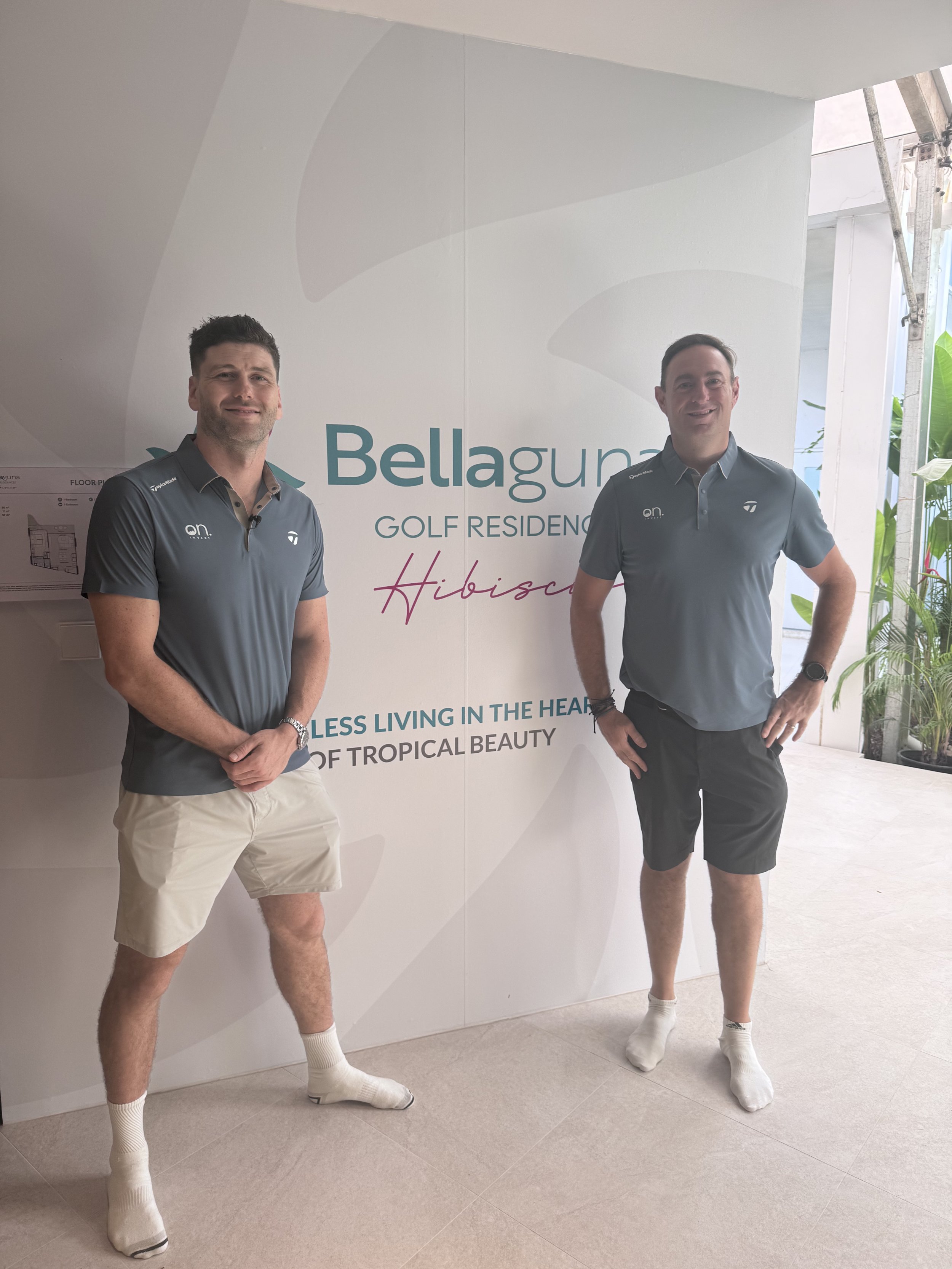 Siôn Bennett and John Treacy standing in front of the Bellaguna Golf Residences signage
