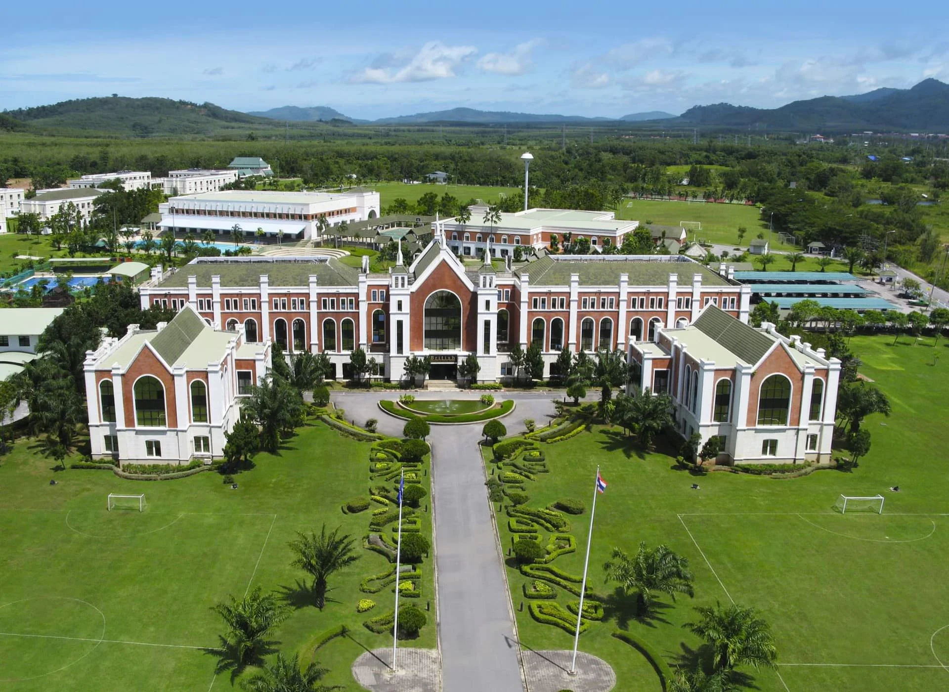 Aerial view of British International School, Phuket, showing its campus buildings, playing fields, and grounds