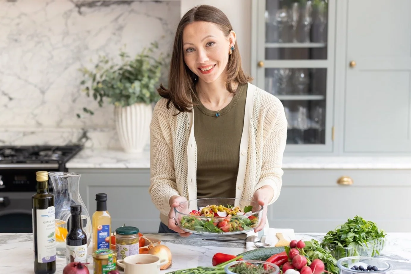 UK-based nutritionist, holding healthy salad and nutritious ingredients