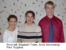 Three students standing together in front of a pixelated background.