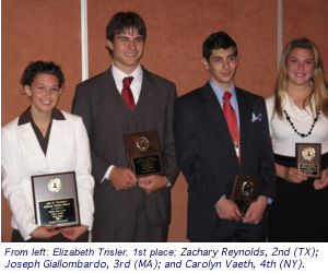 Four young people in formal attire holding plaques, standing together at an awards ceremony.