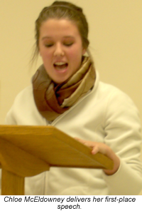 Young woman reading at a podium