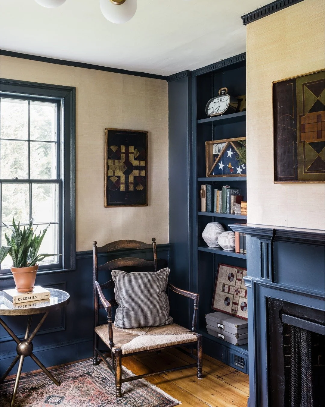 This quiet corner sits in the office in our 1817 Federal farmhouse. We grounded the palette with a light blue and let the collected details speak softly: an antique ladder-back chair, worn pine floors, old books, and game boards gathered over time.

