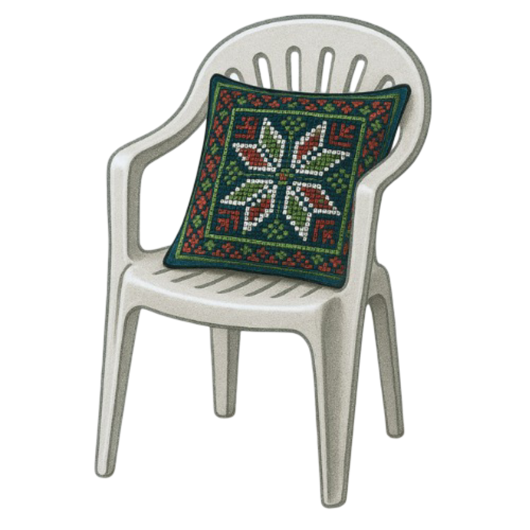 White plastic outdoor chair with a decorative red, white, and green tatreez pillow on it.