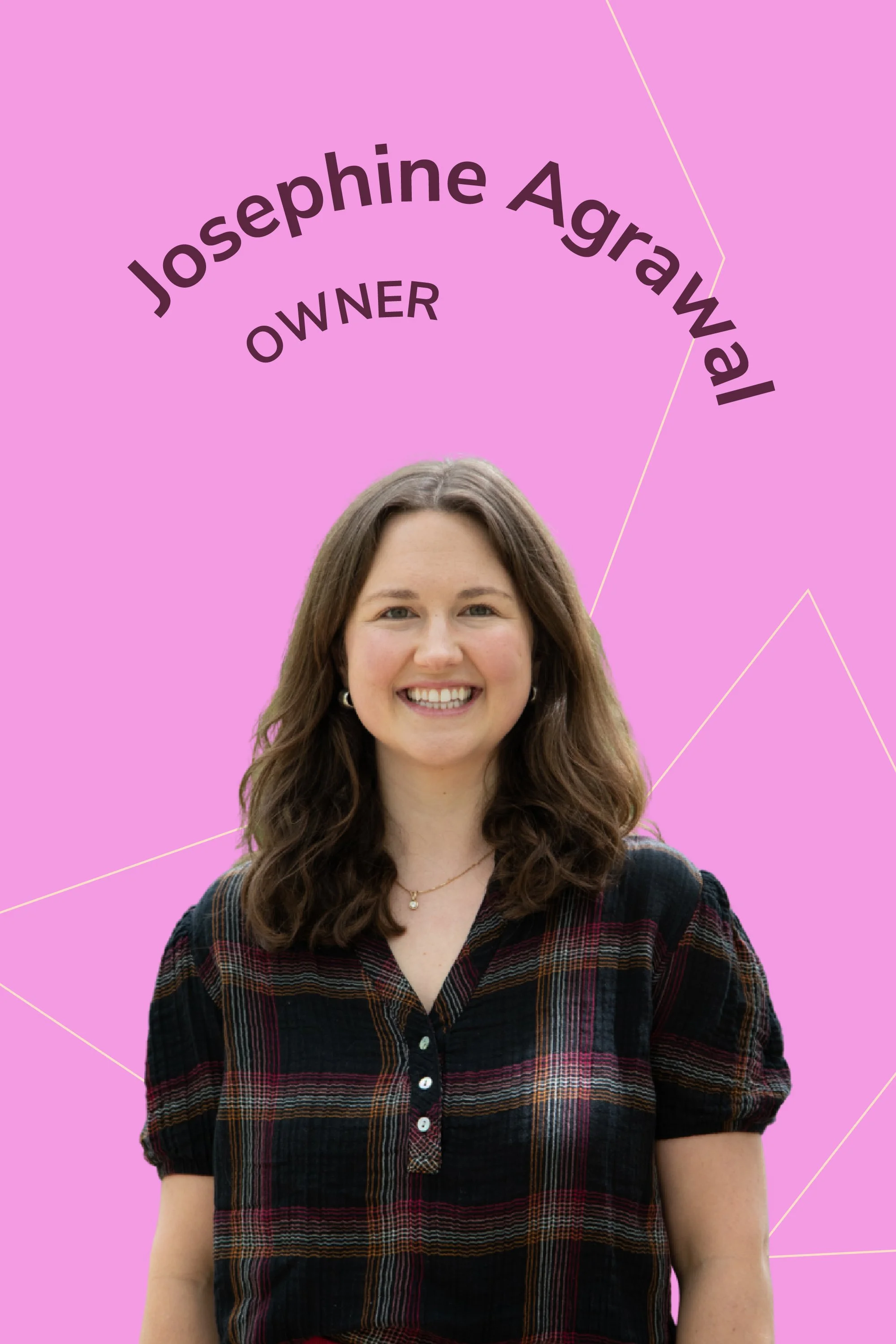 A woman with shoulder-length wavy brown hair, smiling, wearing a black plaid shirt with puffed sleeves, standing against a pink background with purple curved text that reads 'Josephine Agrawal OWNER'.