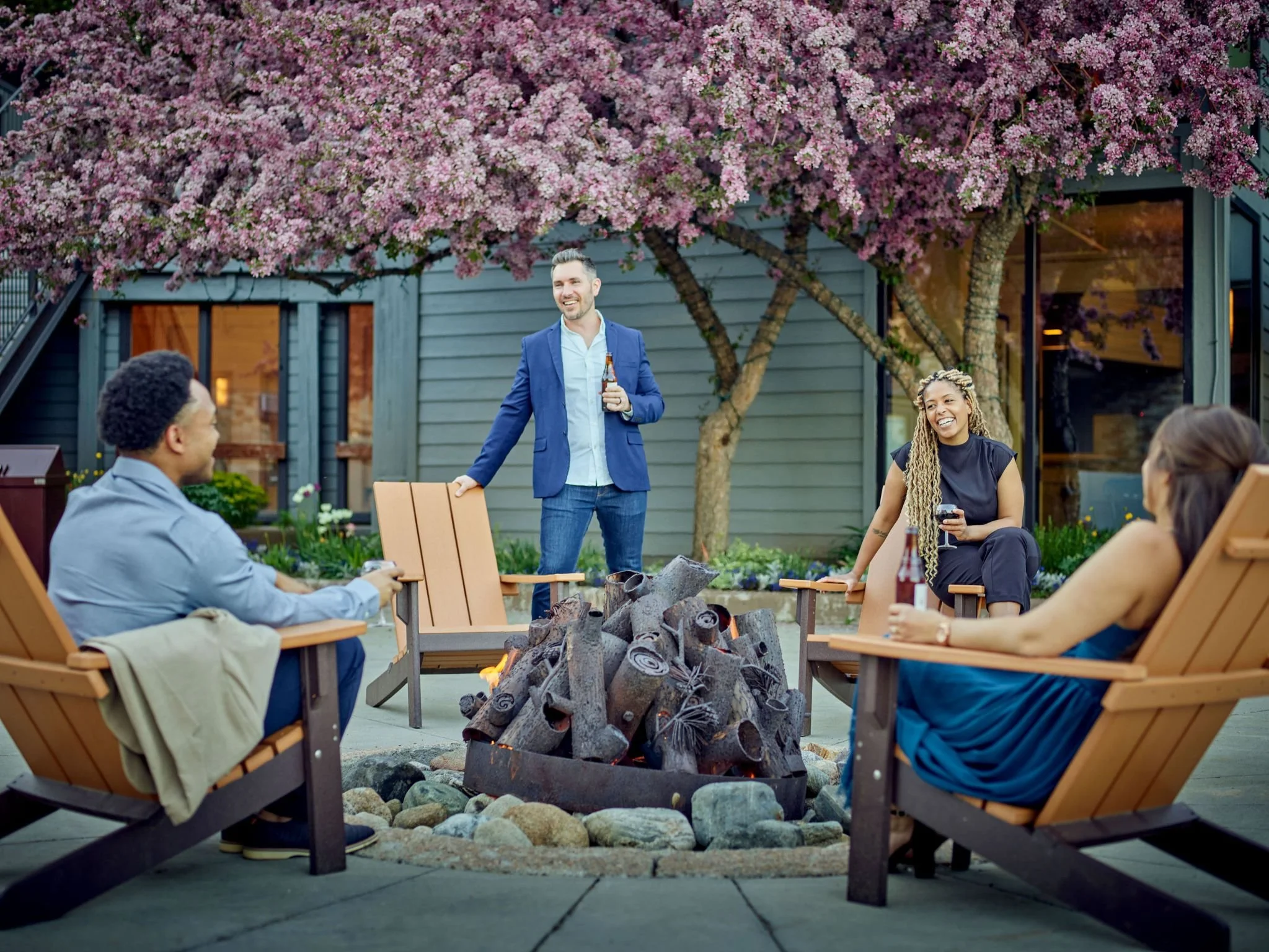 Four people around a fire at Vail Resorts and Meetings.