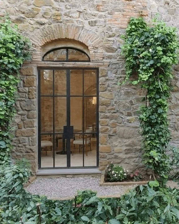 C R I T T A L  D O O R S 

What was once a small window, barely letting in a sliver of natural light, is soon to be a set of double doors with the most beautiful arched detail at the top. The difference in light and space this will make to the room i