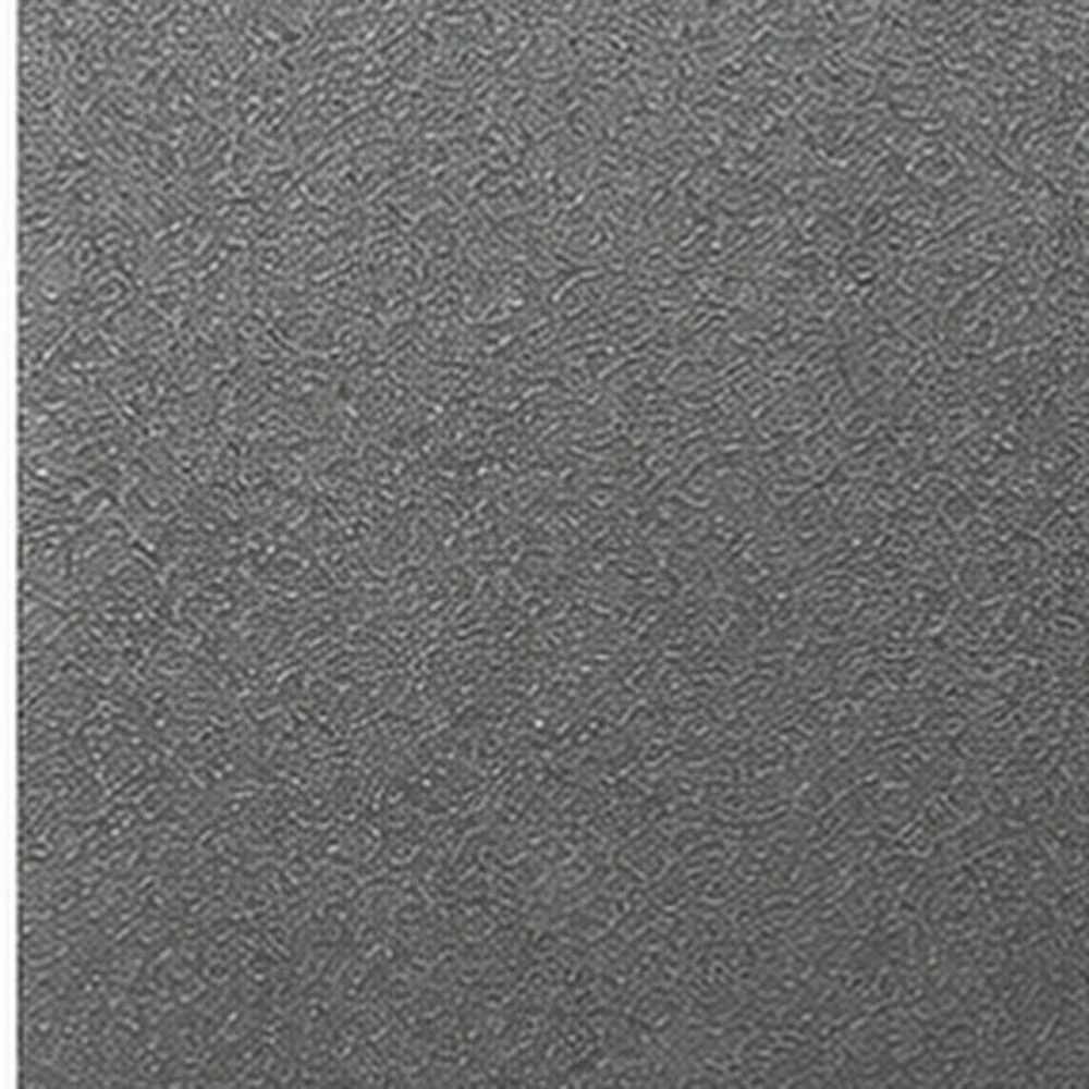 Close-up of a textured, beige and brown stone or concrete surface.