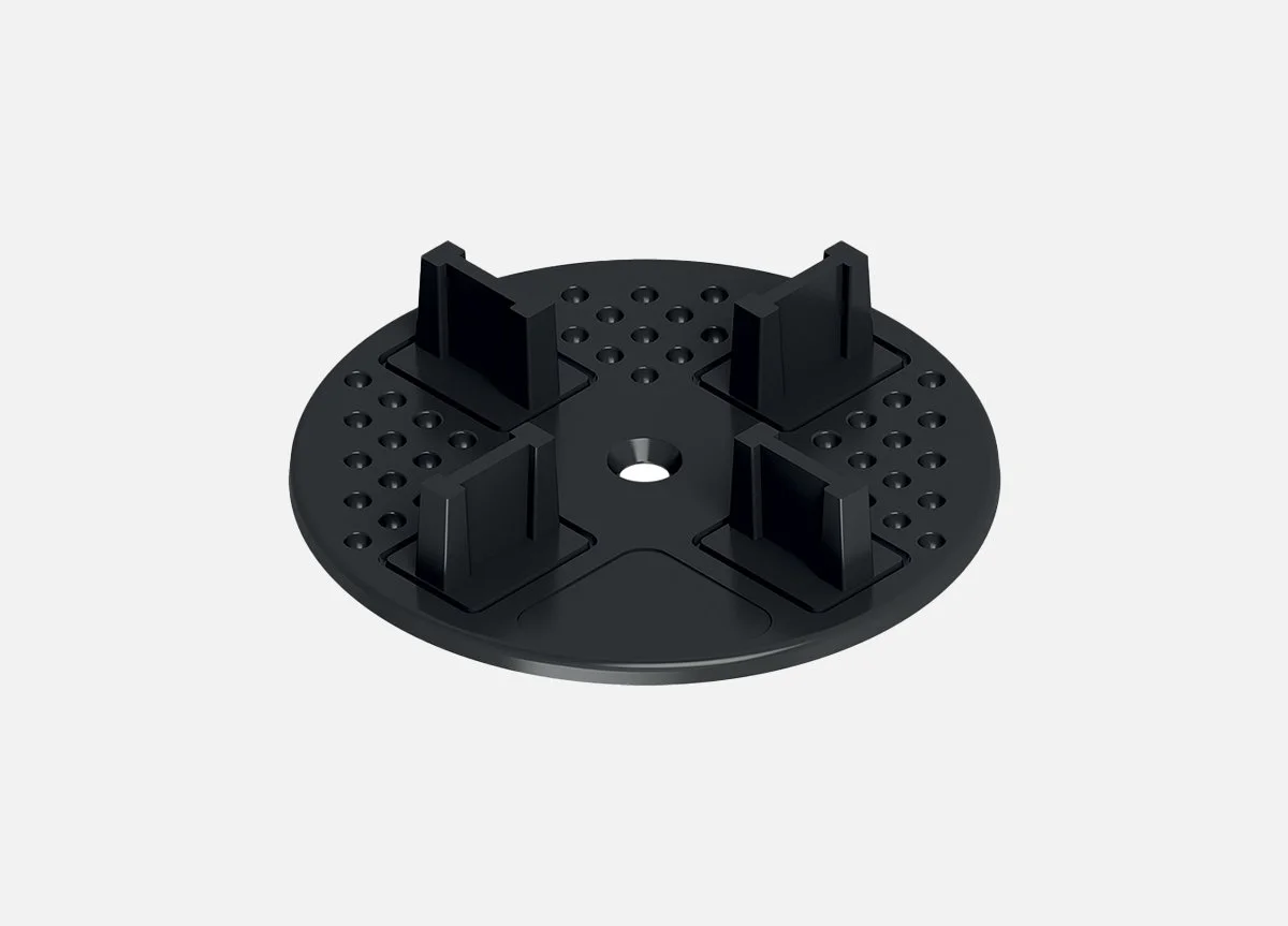 A black plastic mount with four vertical brackets and a central hole, attached to a spike for securing in the ground.