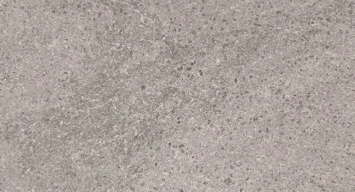 Close-up of a paved stone surface arranged in a herringbone pattern.