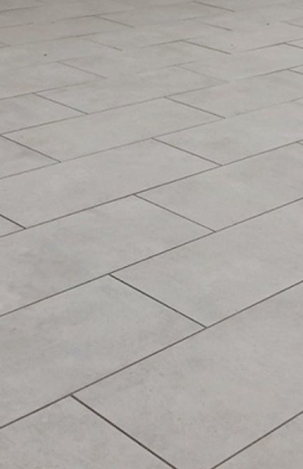 Light gray tiled floor with rectangular tiles.