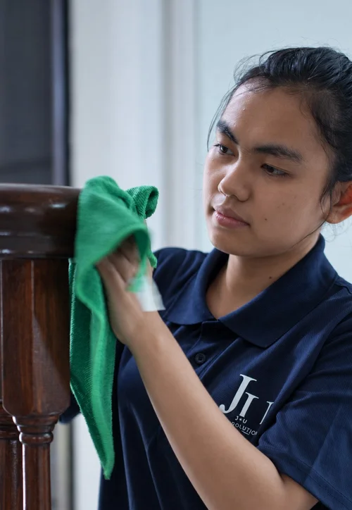 J+U cleaner wiping a surface inside a home