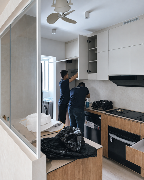 J+U team cleaning kitchen cabinets after renovation
