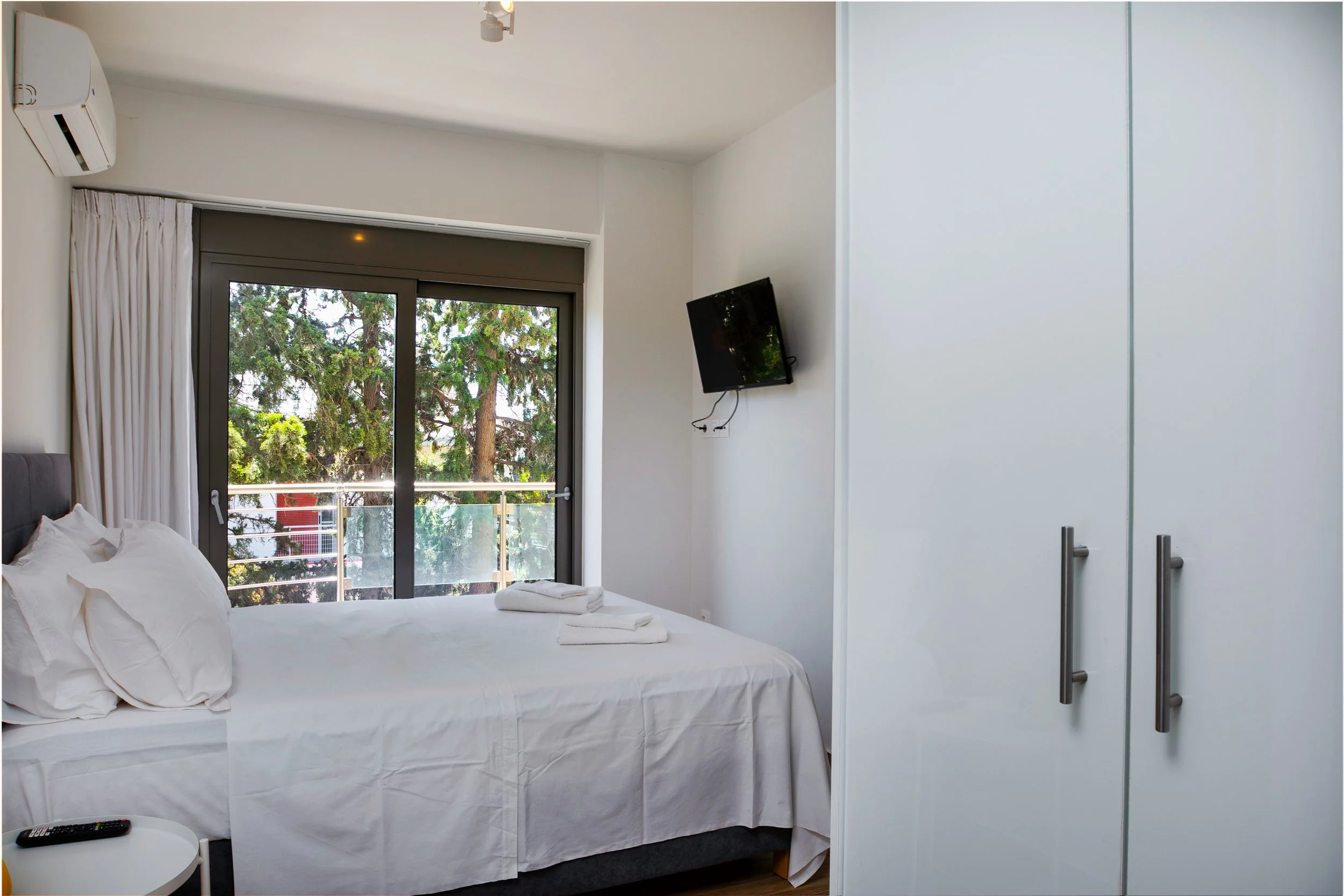 Bedroom with balcony doors and built-in wardrobe
