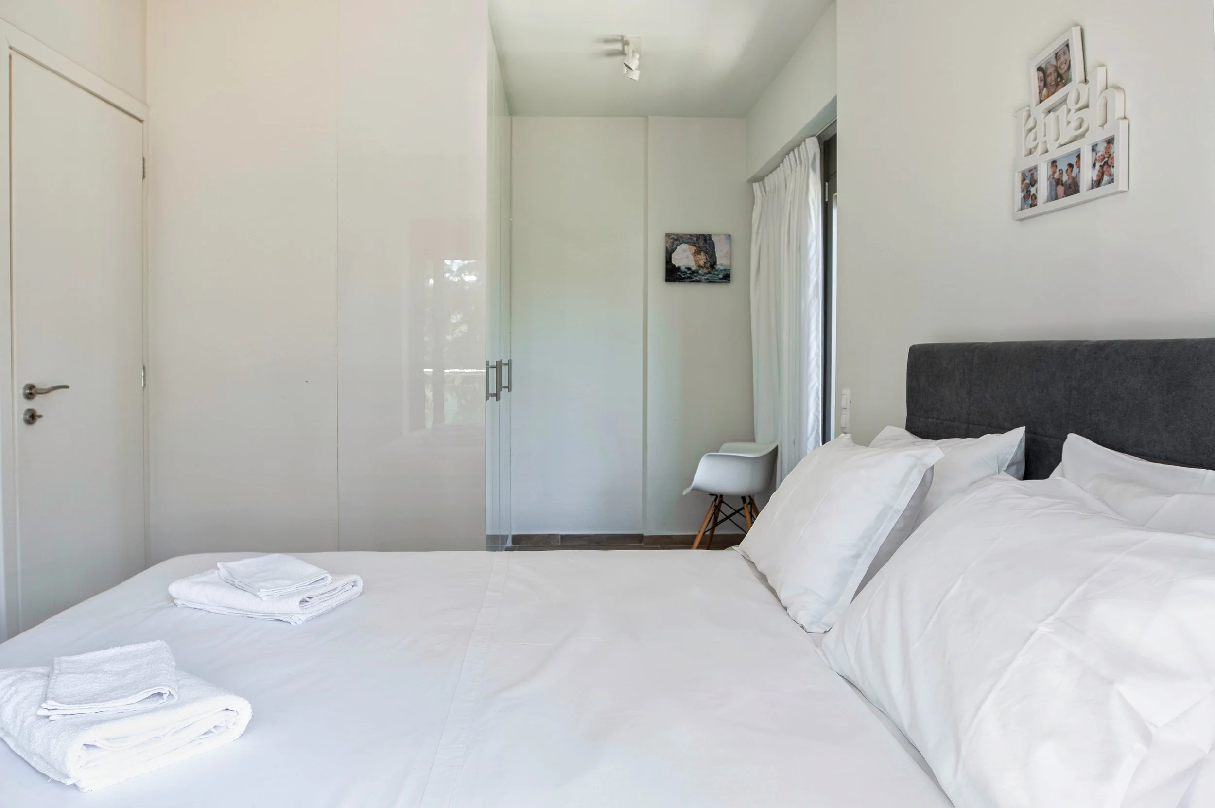 Primary bedroom — serene, all-white linens