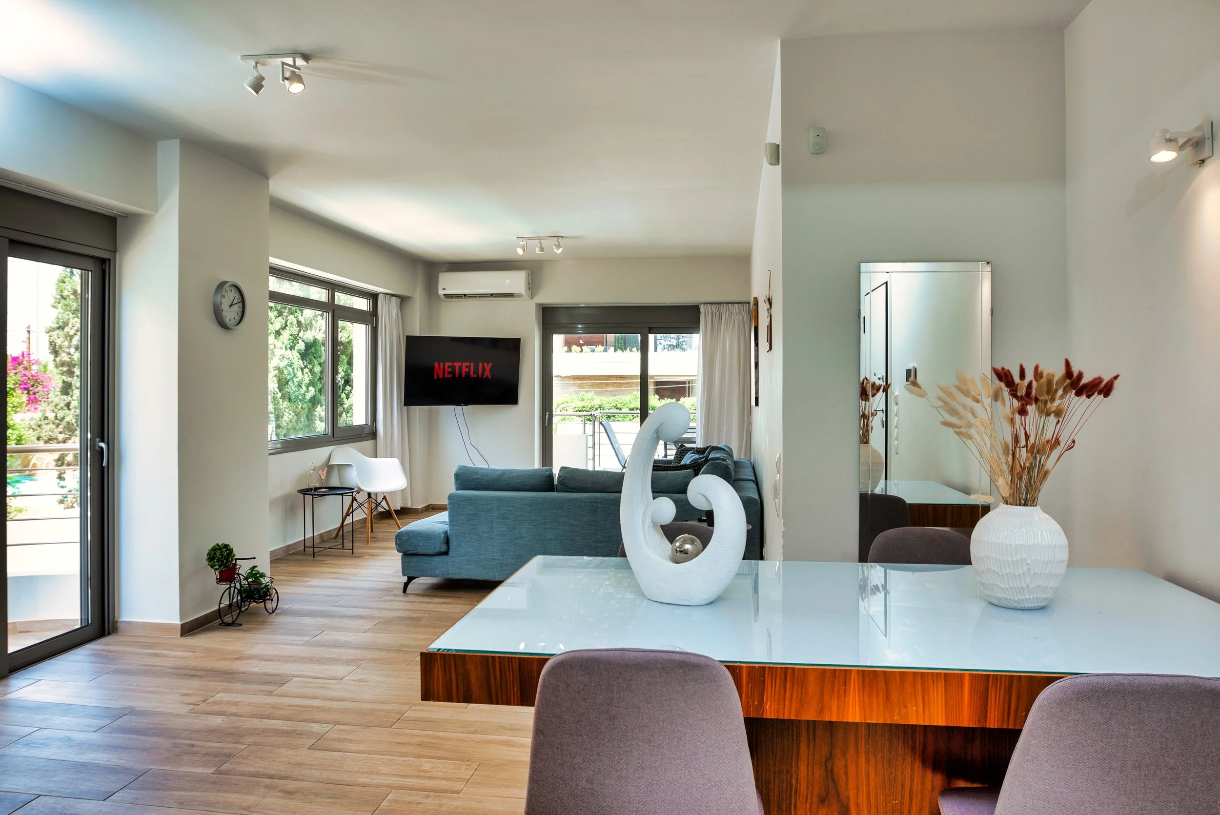 Open plan layout with TV and balcony beyond