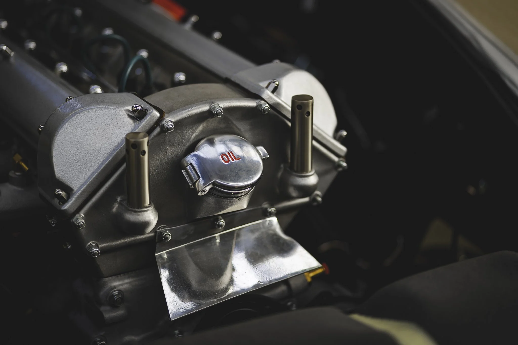Close-up of a car engine with an oil cap labeled 'OIL'.