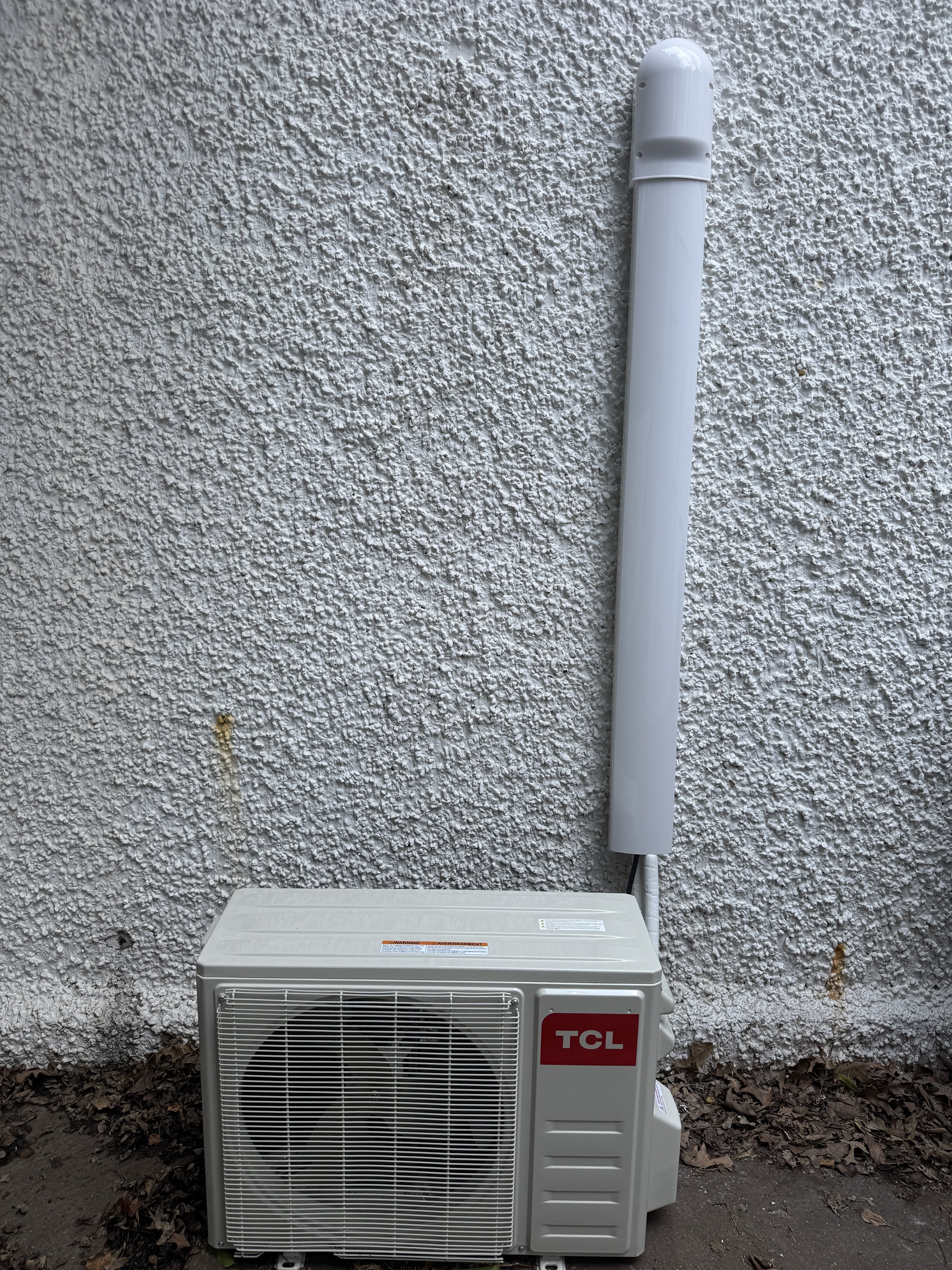 Clark HVAC TCL ductless mini-split outdoor unit with professionally installed line set hide cover on a stucco wall