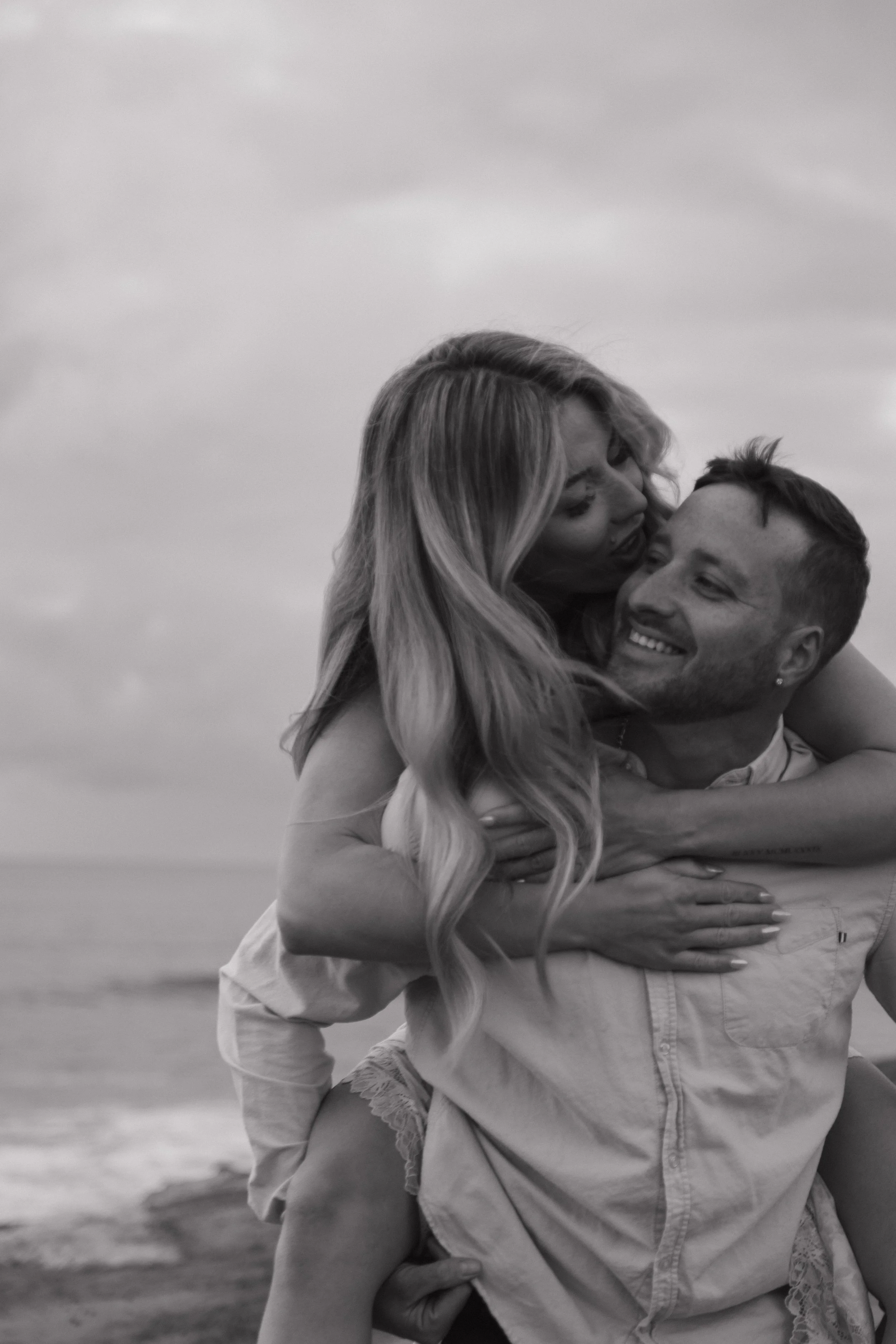 Couple walking along Sunset Cliffs in San Diego during sunset lifestyle engagement session