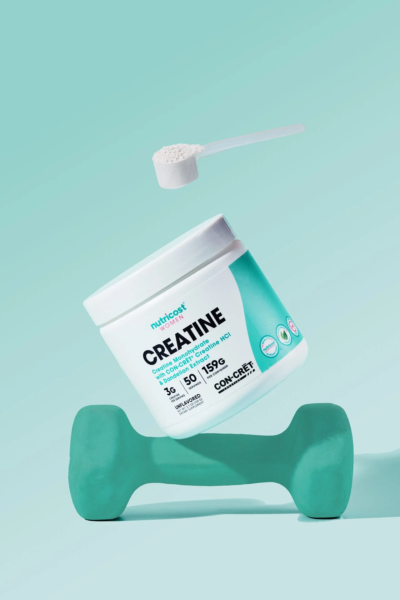 A container of creatine powder balancing on a teal dumbbell with a scoop of powder above it, set against a light teal background.