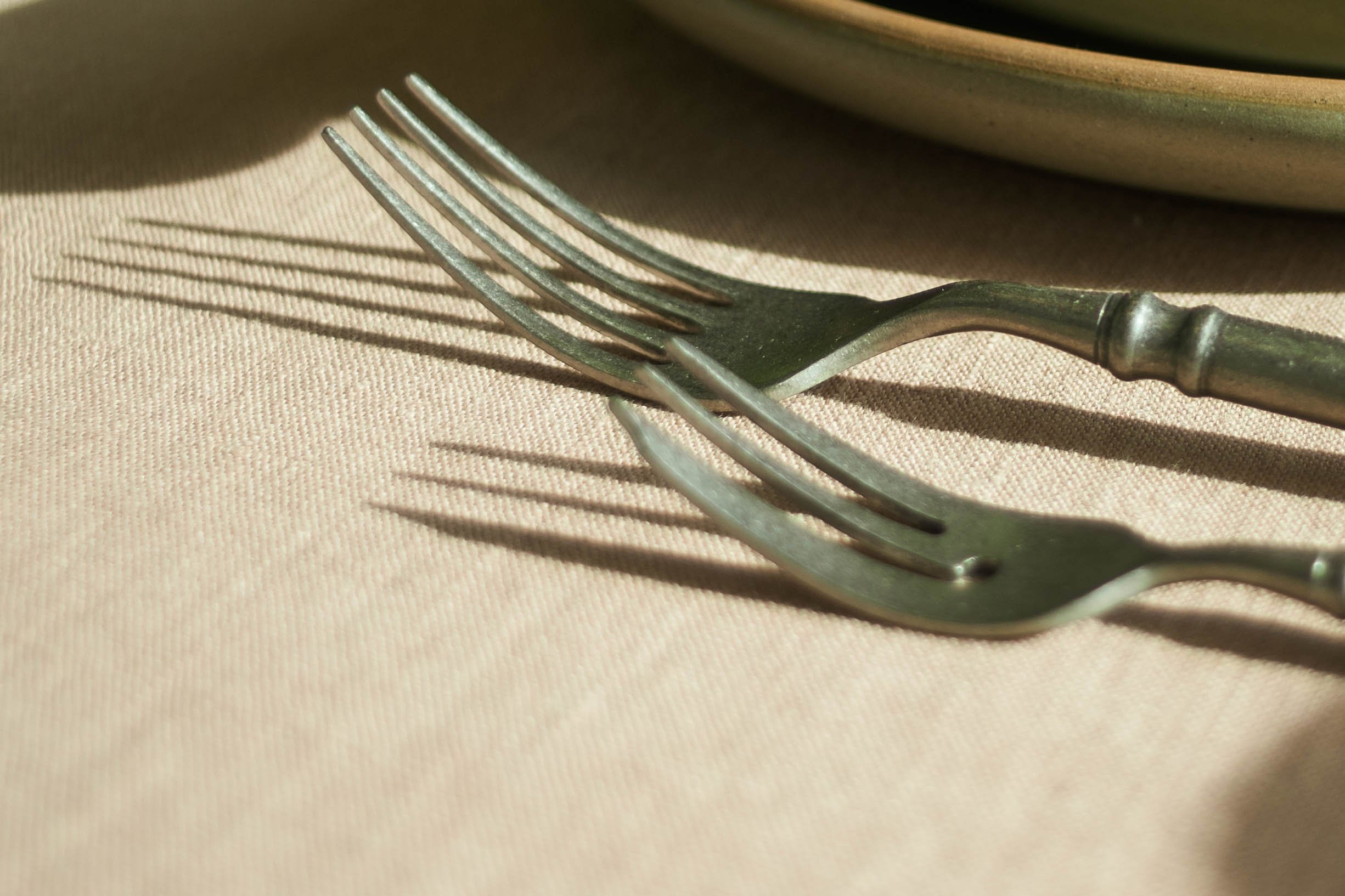 Closeup of the fork and dessert fork included in the Vintage look Stonewash Cutlery Set