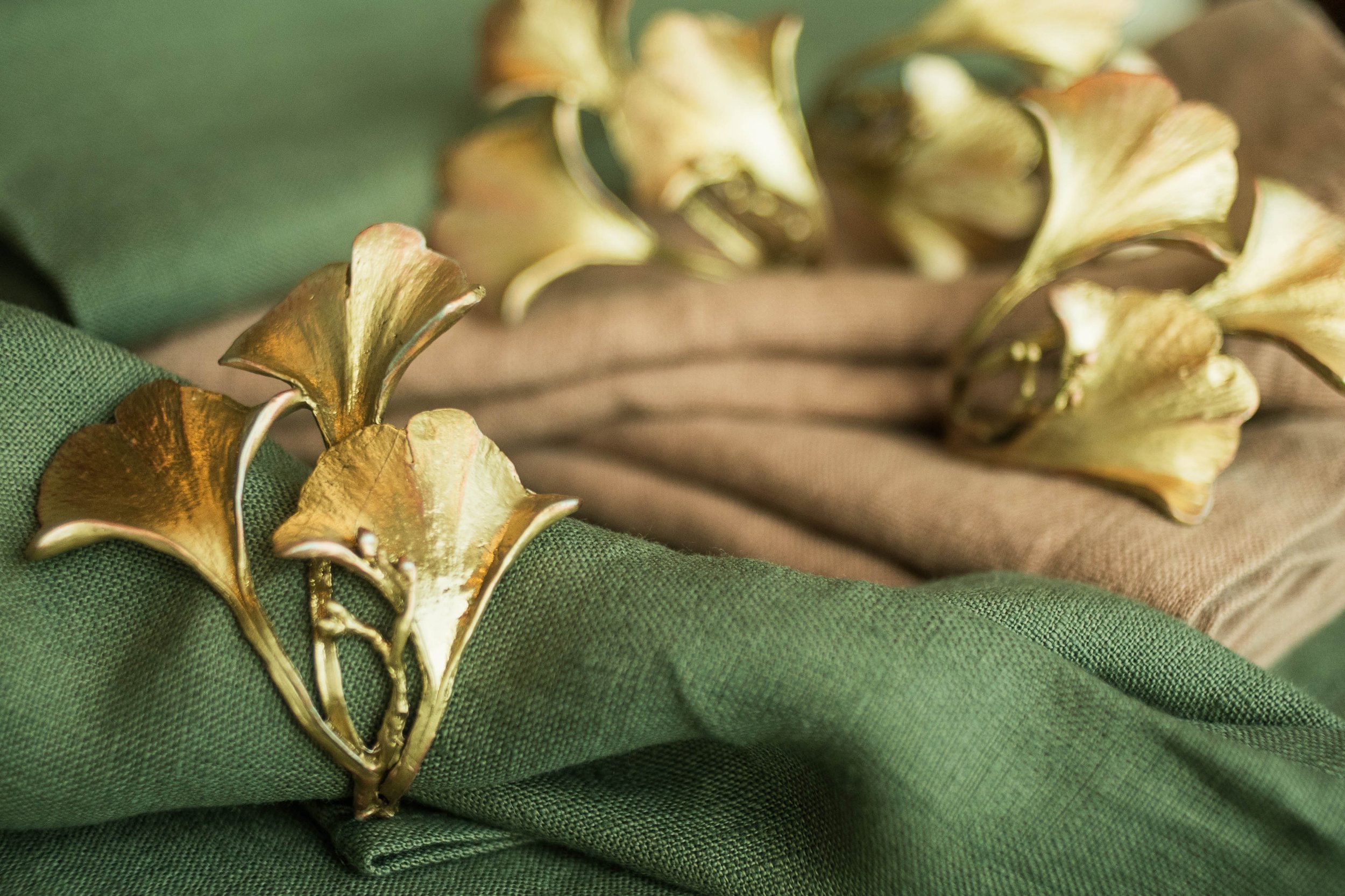 Ginkgo Leaf Napkin Rings on a stone green linen