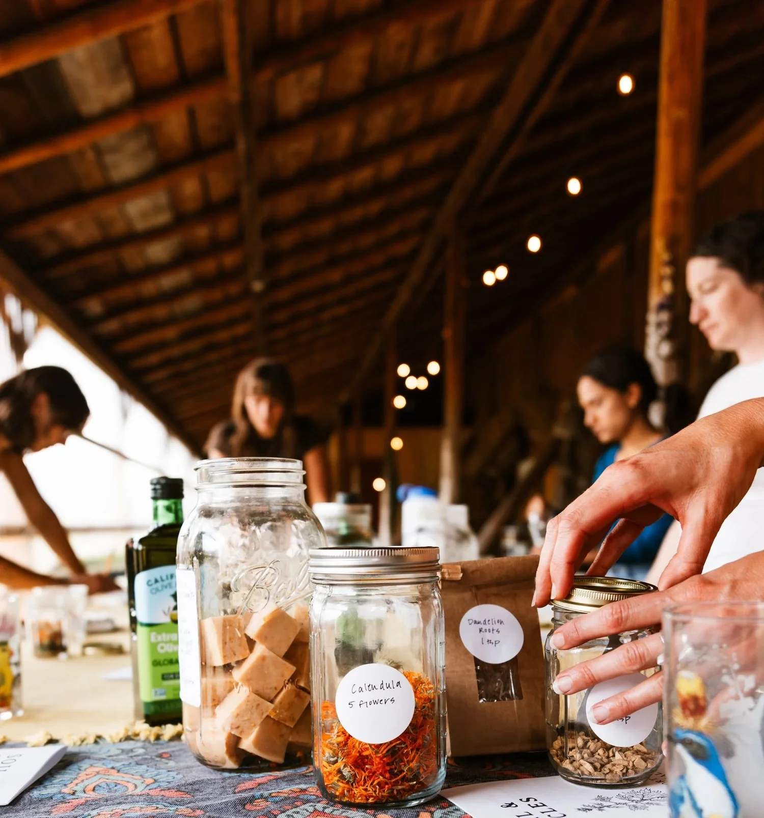 Jars of herbs, spices, and preserves on a farmhouse table